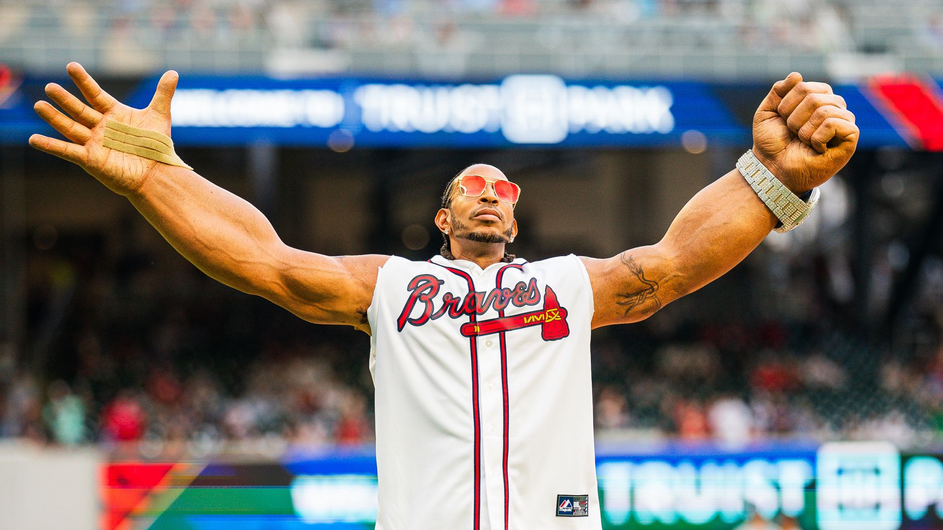 Ludacris slipped on the oversized arms made famous in his "Get Back" music video to throw out the ceremonial first pitch before the game between the Atlanta Braves and the Colorado Rockies at Truist Park yesterday.