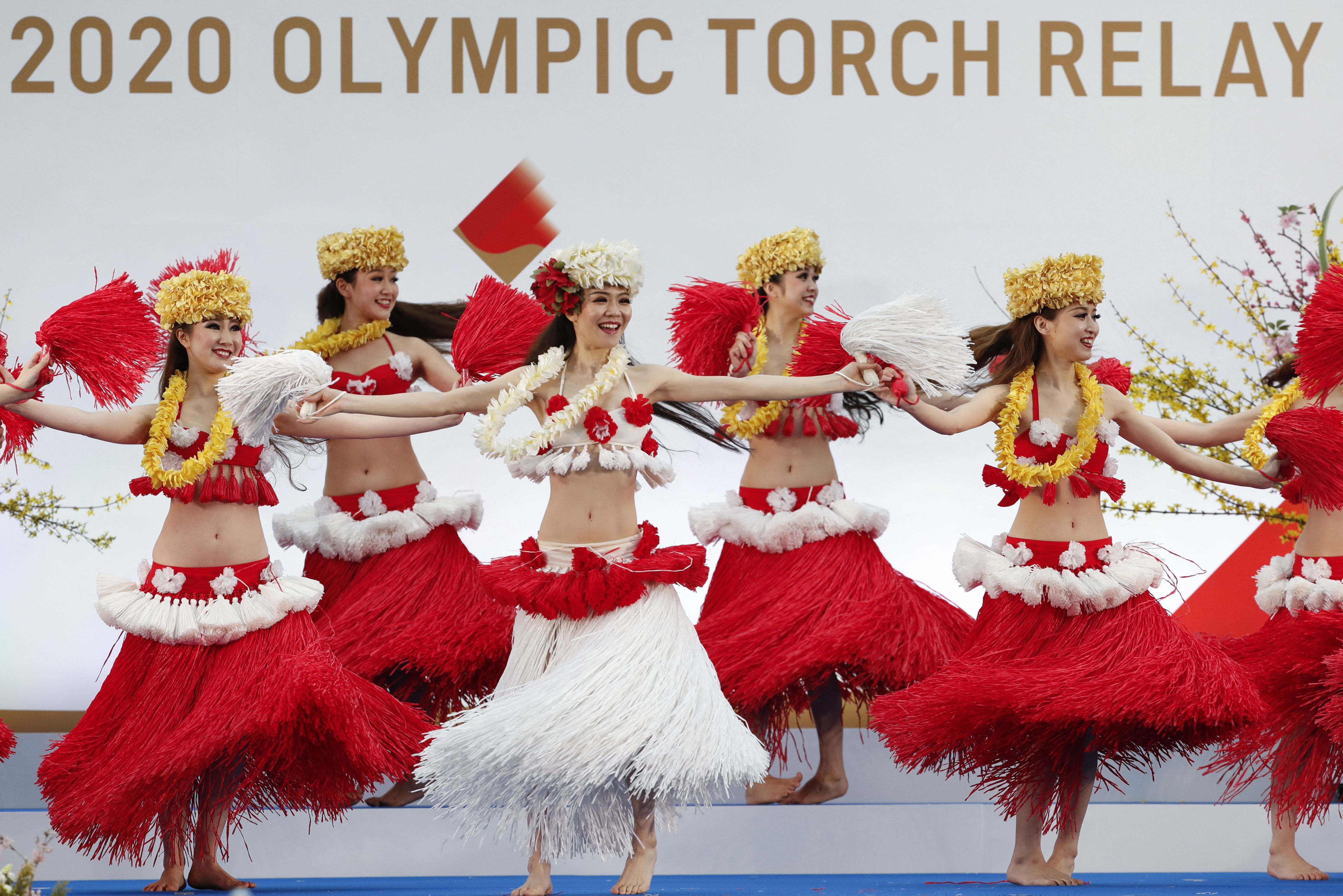 Members of the Spa Resort Hawaiians Dancing Team "Hula Girls" perform during an opening ceremony on the first day of the Tokyo 2020 Olympic torch relay in Naraha, Fukushima prefecture on March 25
