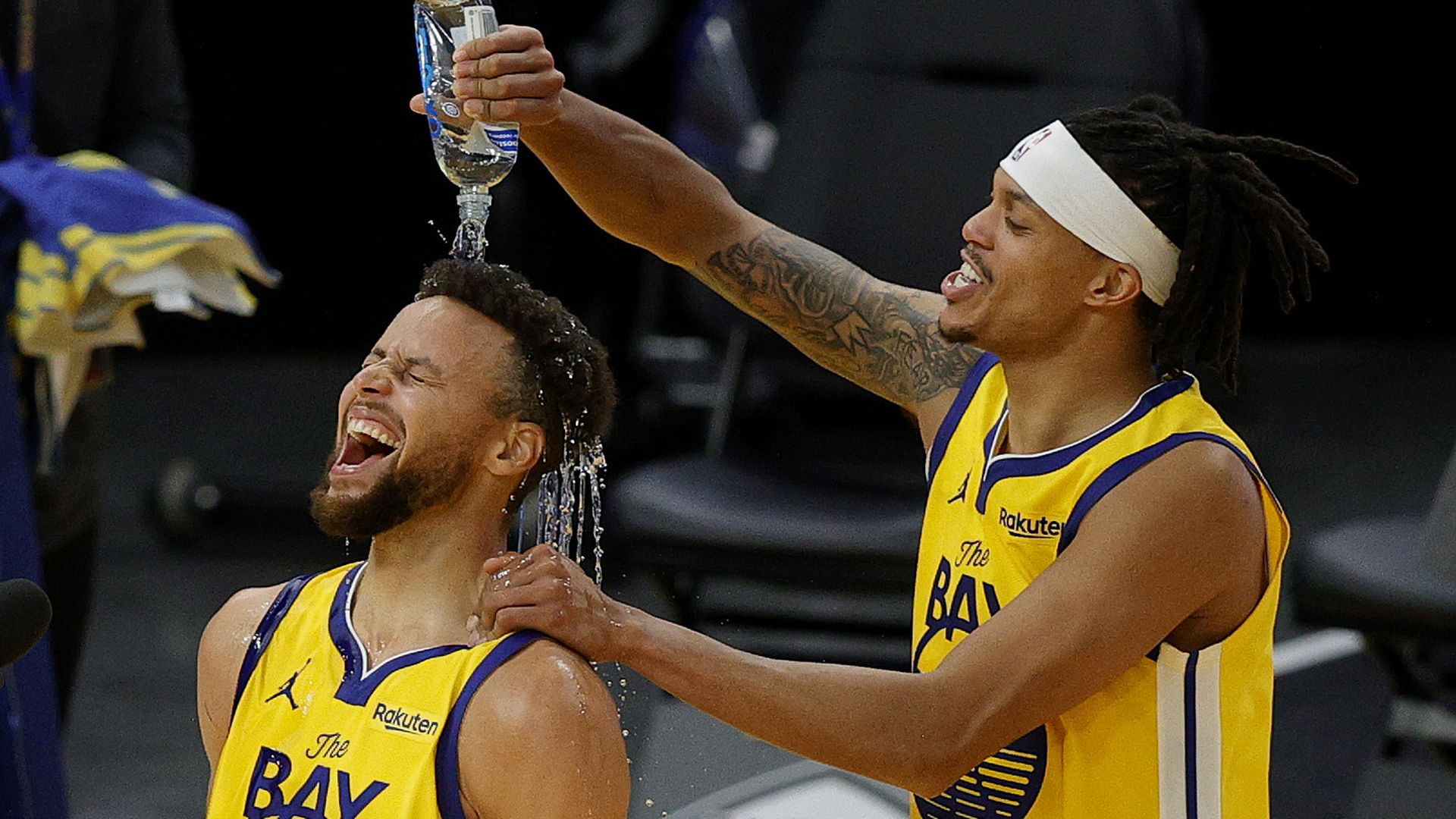 Steph Curry getting water poured on his head
