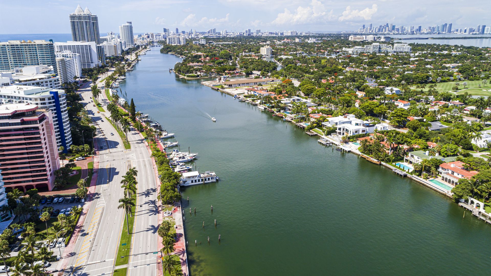 Miami Beach, Florida, aerial view, Indian Creek La Gorce Island Country Club, waterfront property homes and city skyline.
