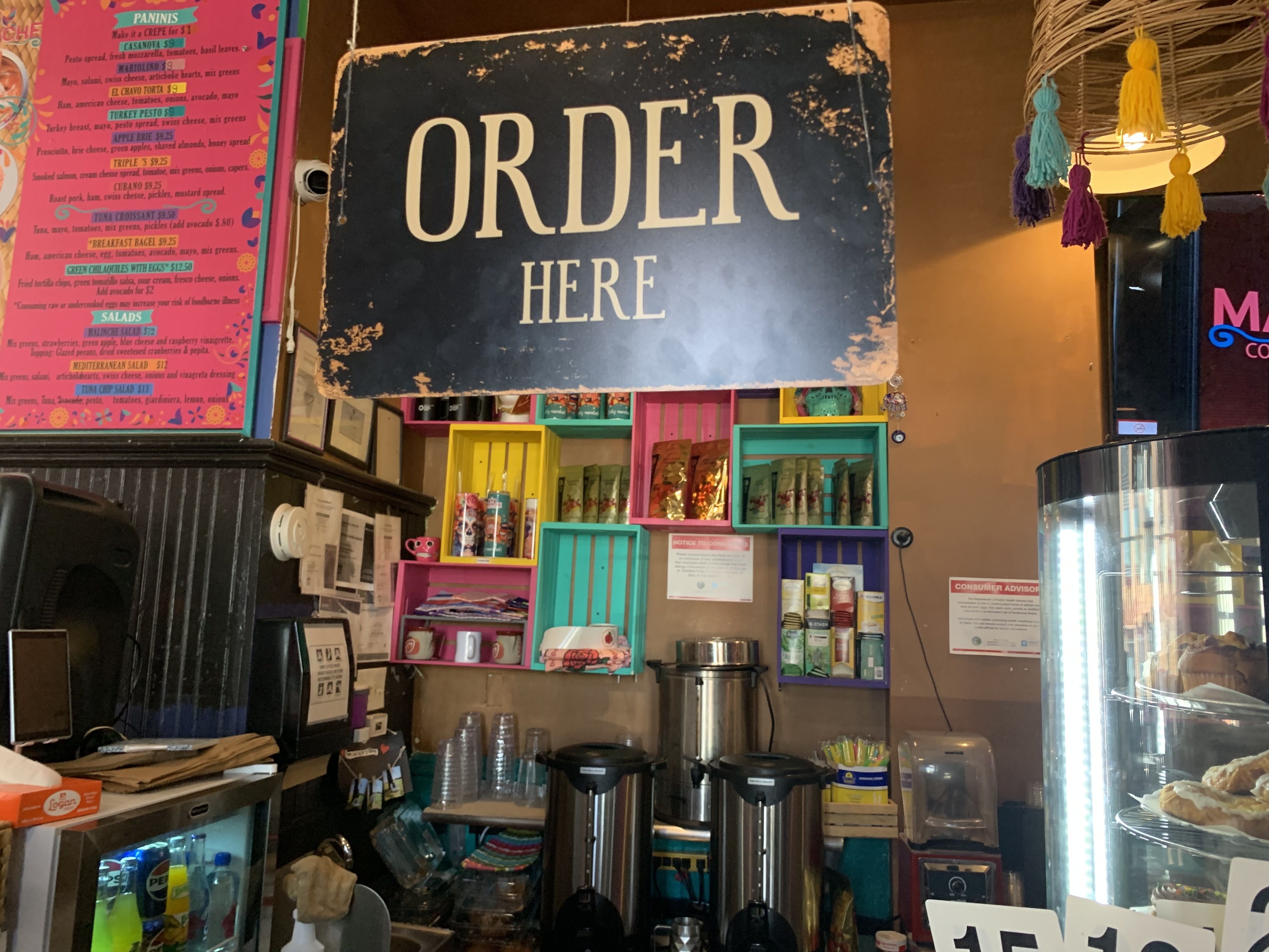 Photo of a coffee counter that says "Order Here" 