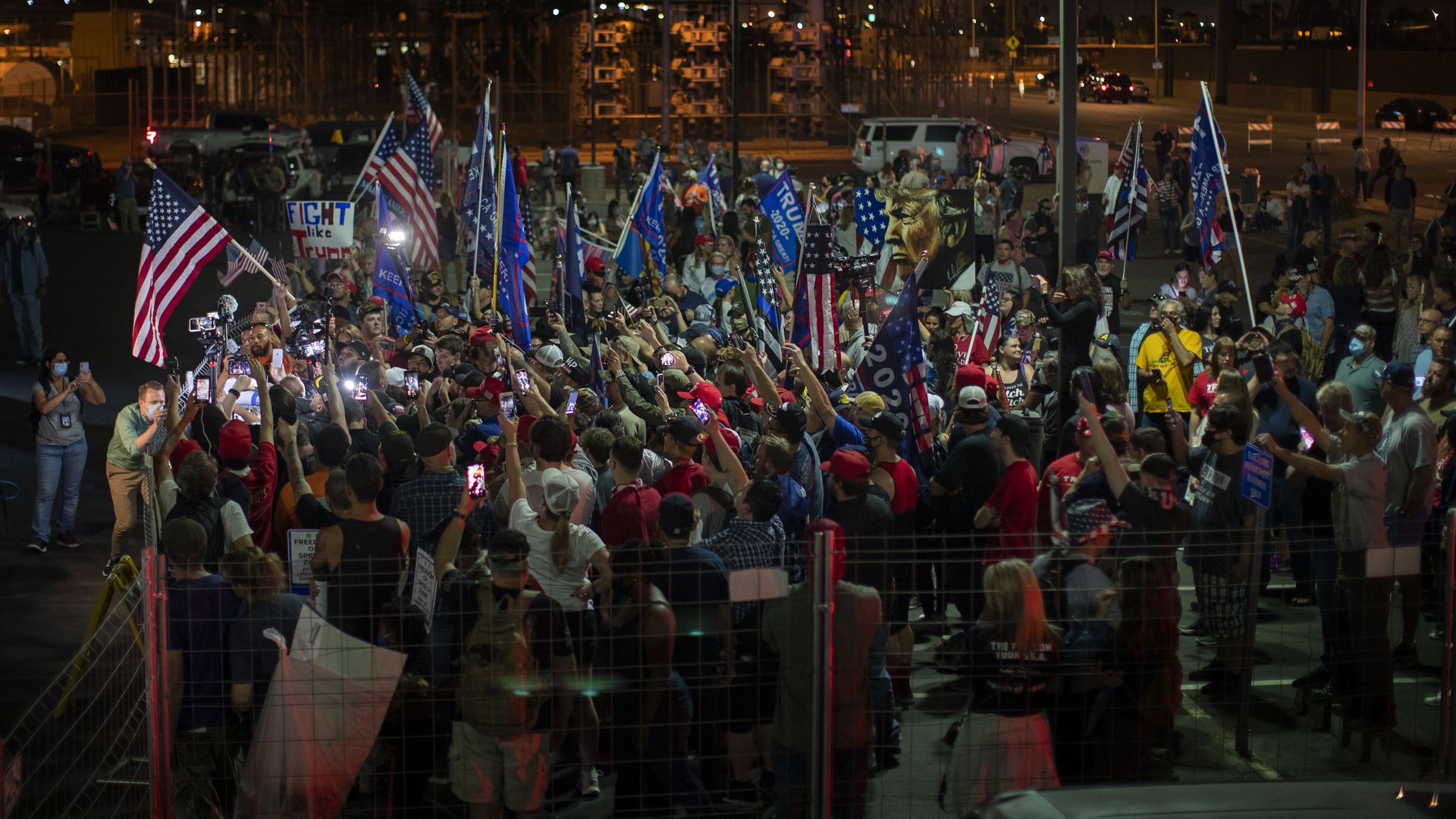 Protesters with America and Trump flags.