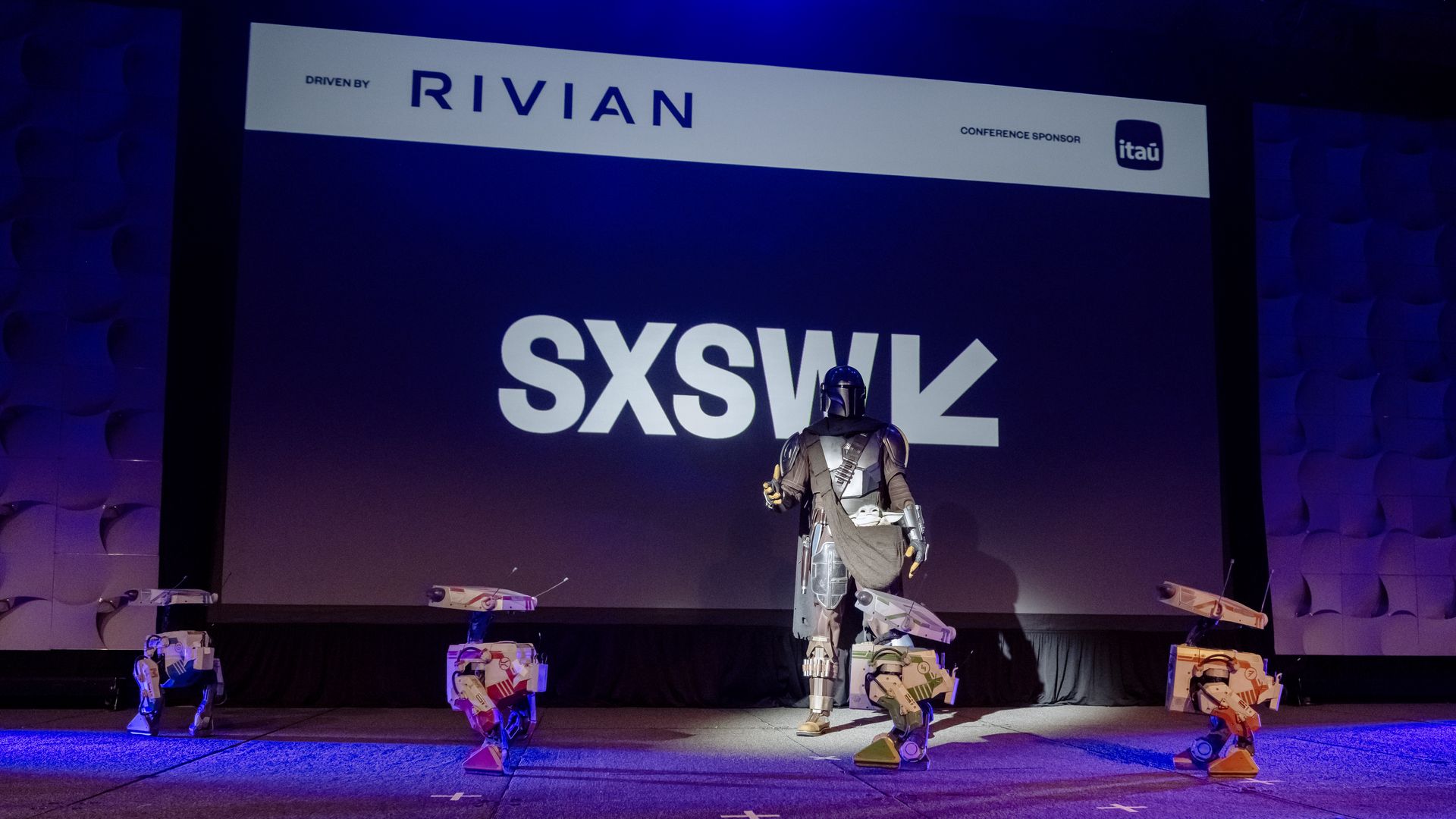 AUSTIN, TEXAS - MARCH 08: The Mandalorian appears on stage with robots during the Featured Session 'The Future of World Building at Disney' on March 08, 2025 in Austin, Texas. (Photo by Astrida Valigorsky/Getty Images)