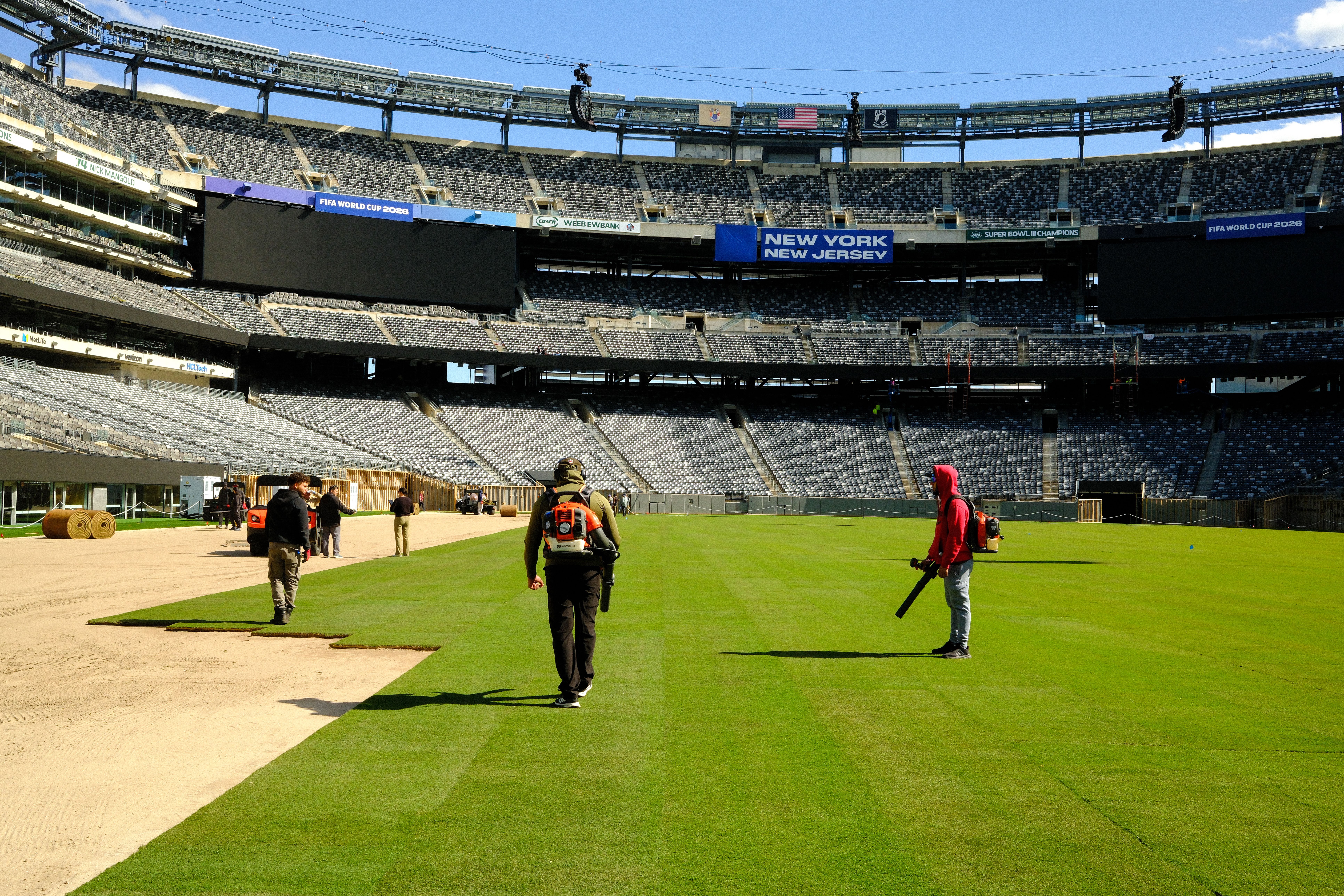 Workers install a grass field at MetLife Stadium — temporarily renamed New York New Jersey for the World Cup — last week. The Giants and Jets play on artificial turf.