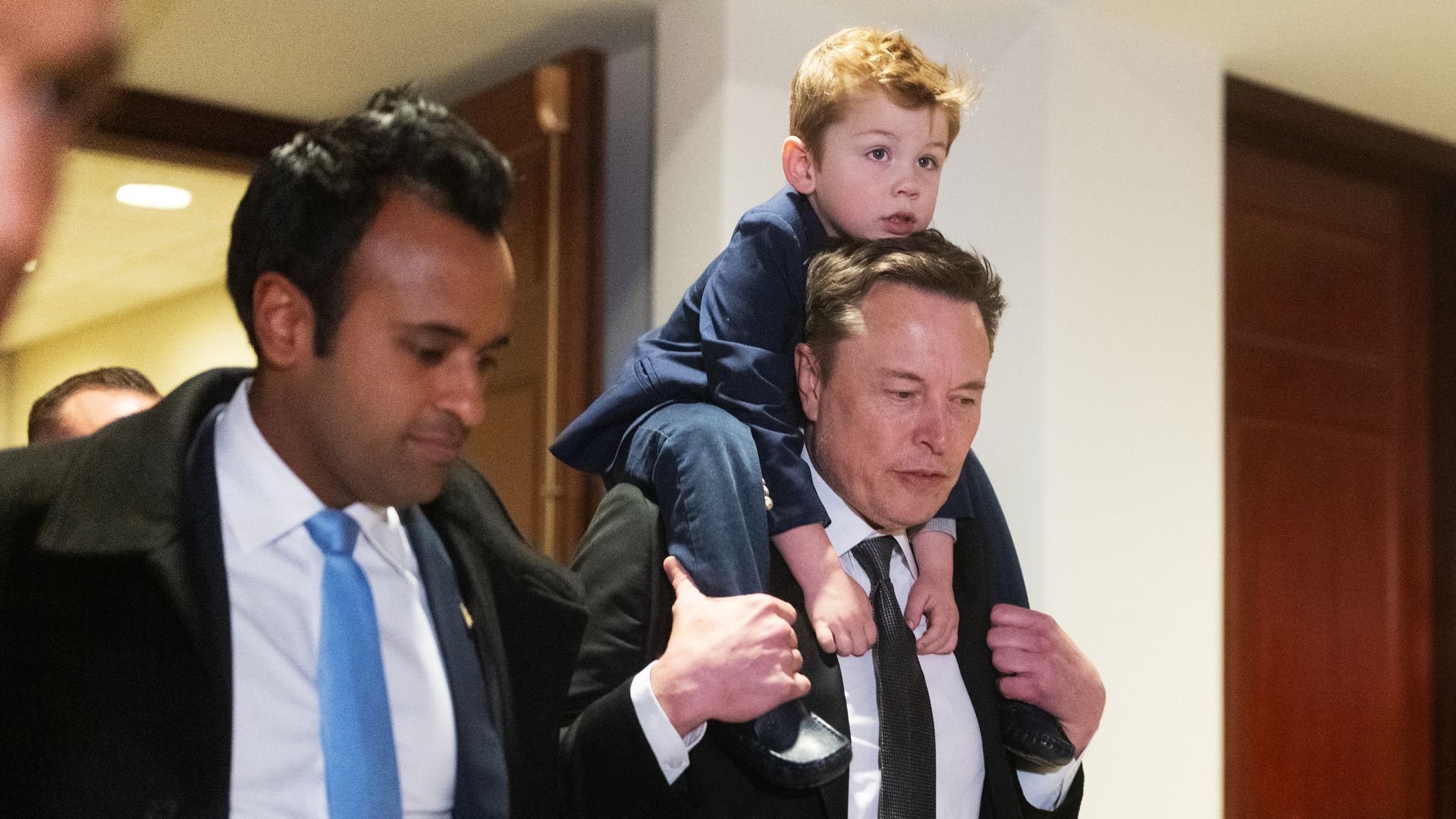 Vivek Ramaswamy and Elon Musk, with his son in the Capitol building.