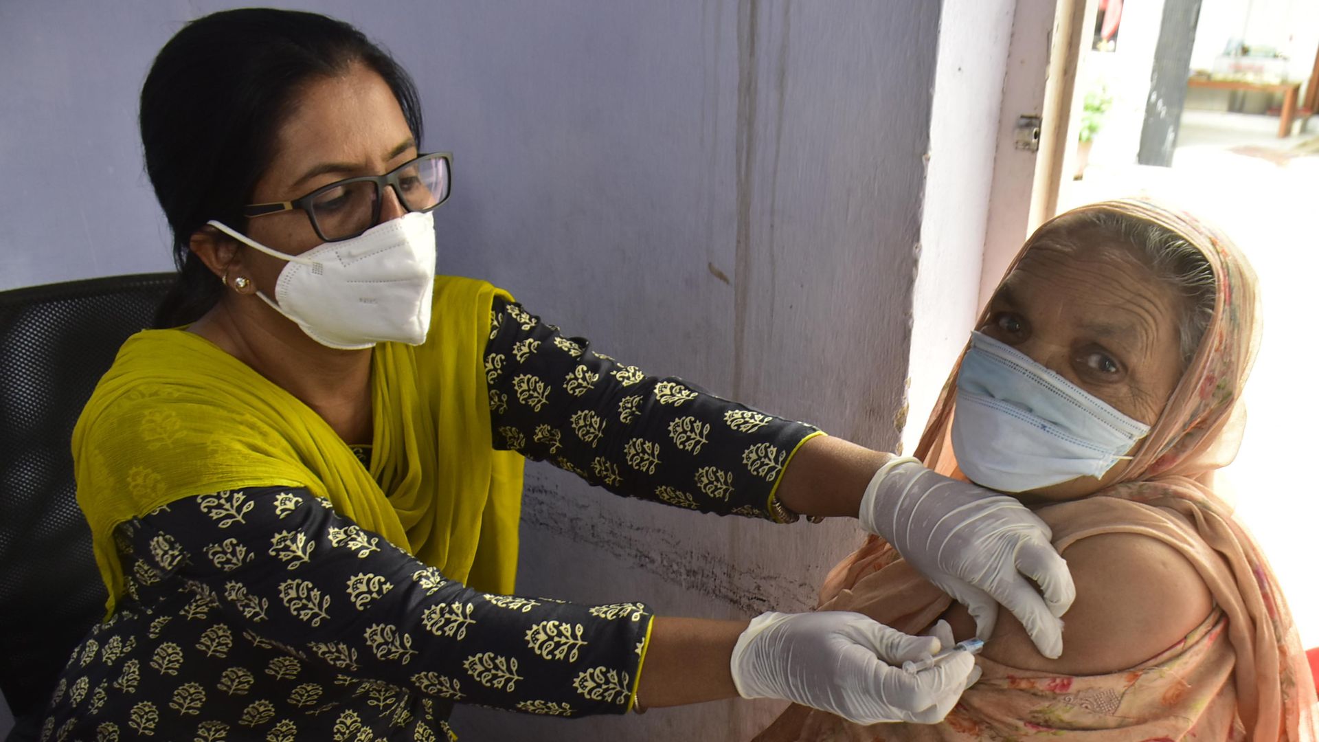 A healthcare worker administering a coronavirus vaccine in Amritsar, India, on April 15.
