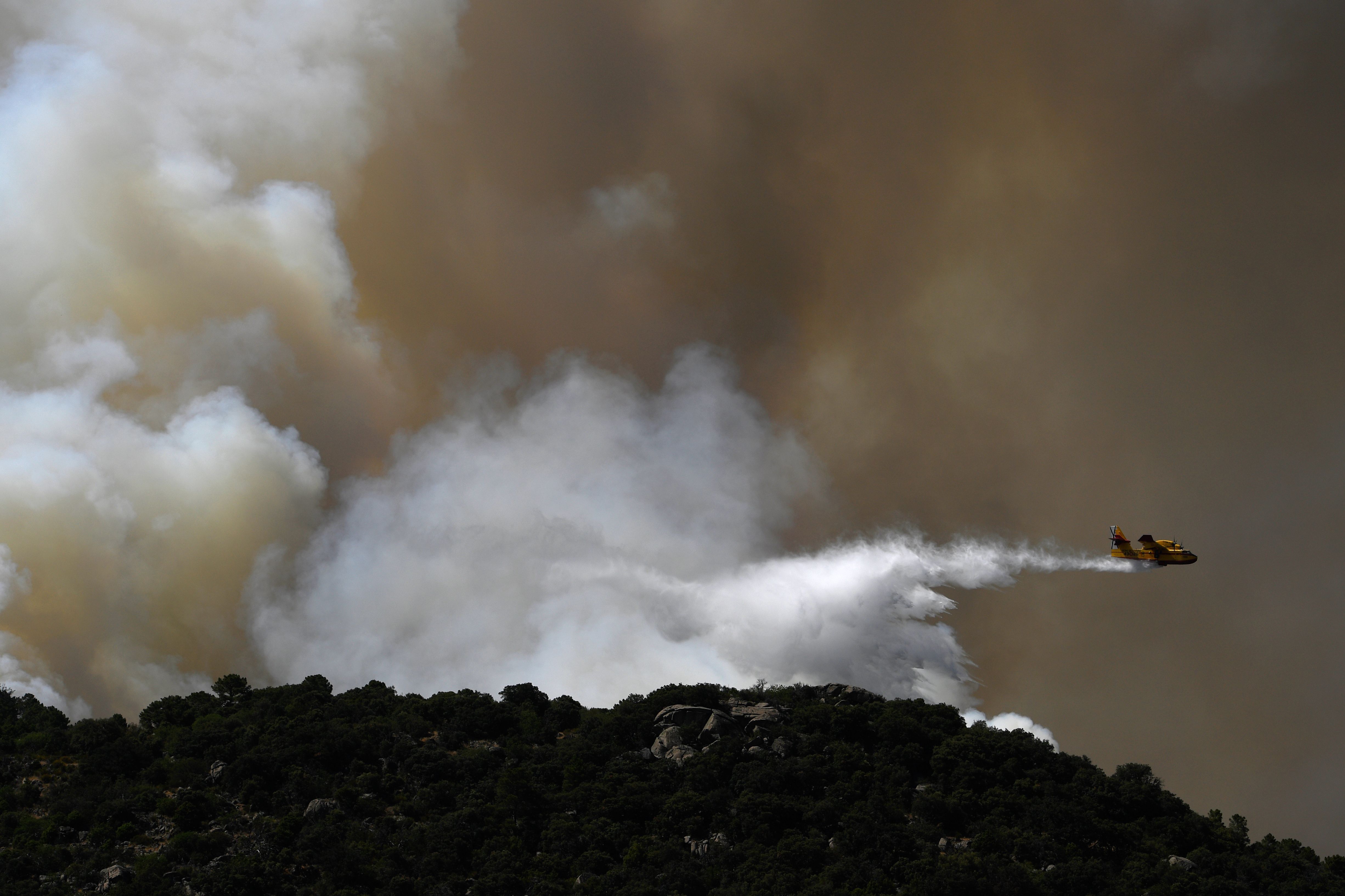 Firefighters battle a wildfire in central Spain. The country has been hit with a series of wildfires as temperatures remained sky-high at the weekend, per AFP.