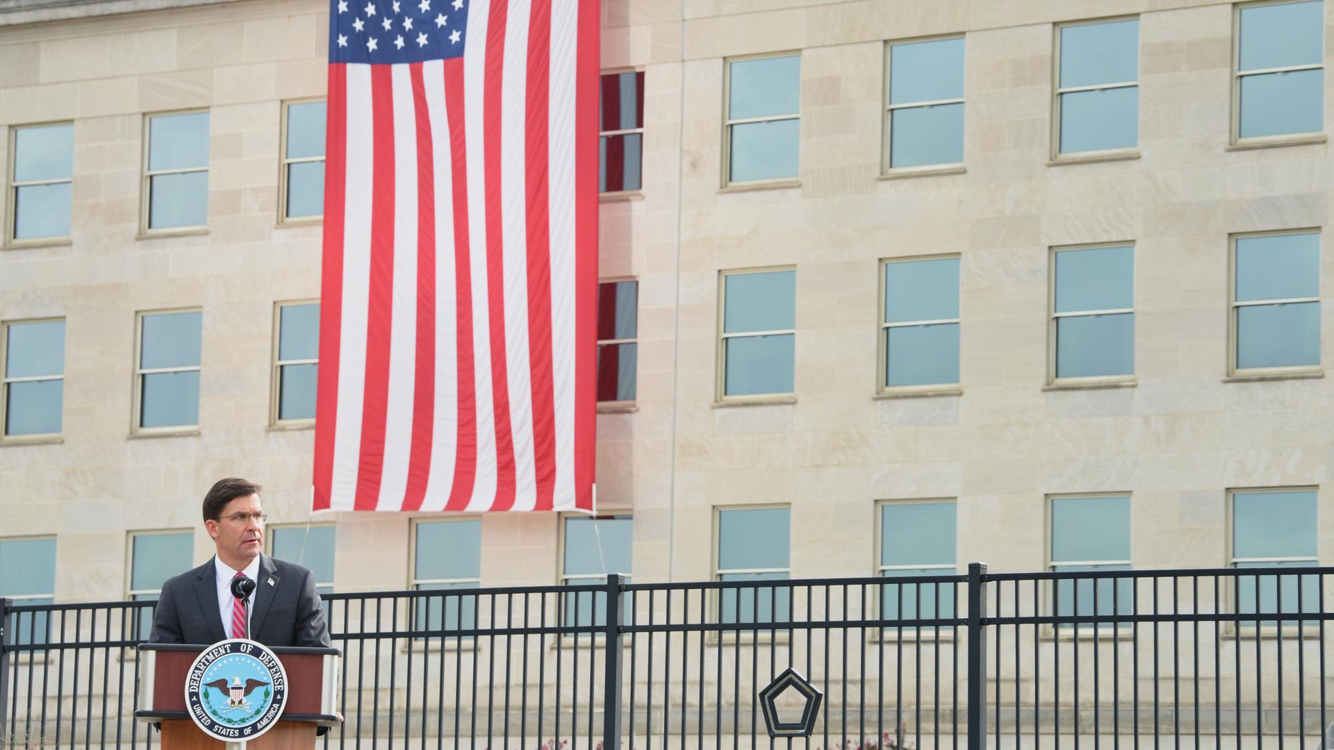 Photo of Mark Esper standing at a podium giving a speech