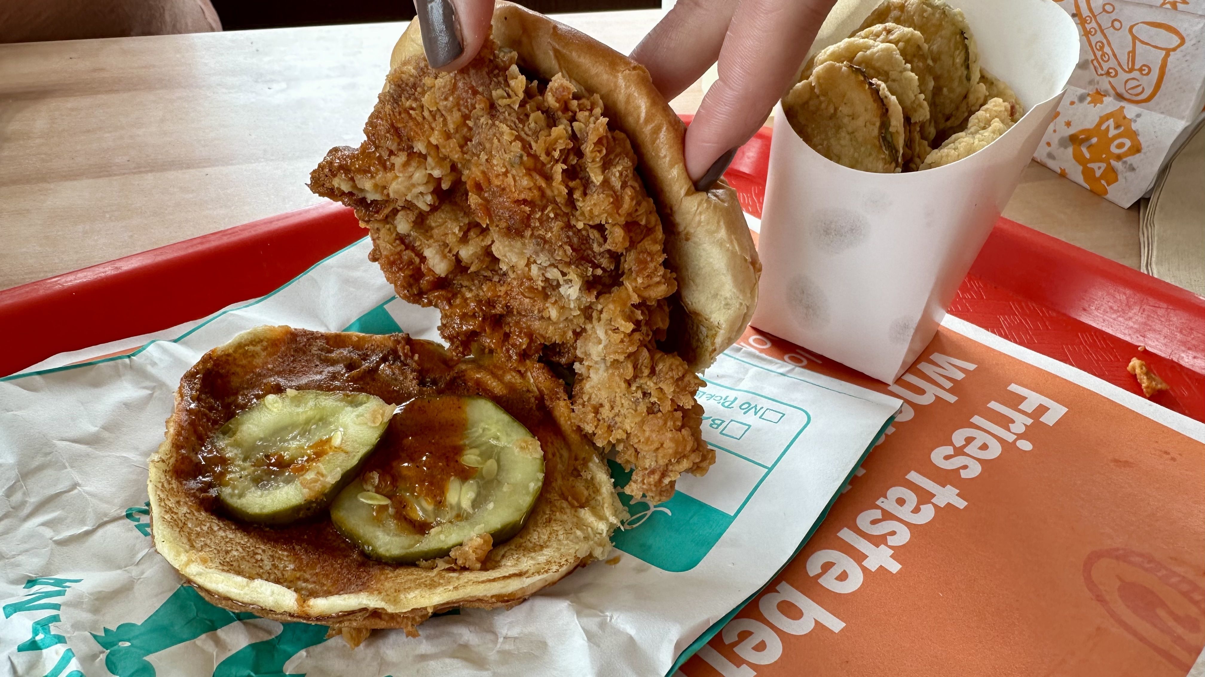 Photo shows a chicken sandwich with pickles.