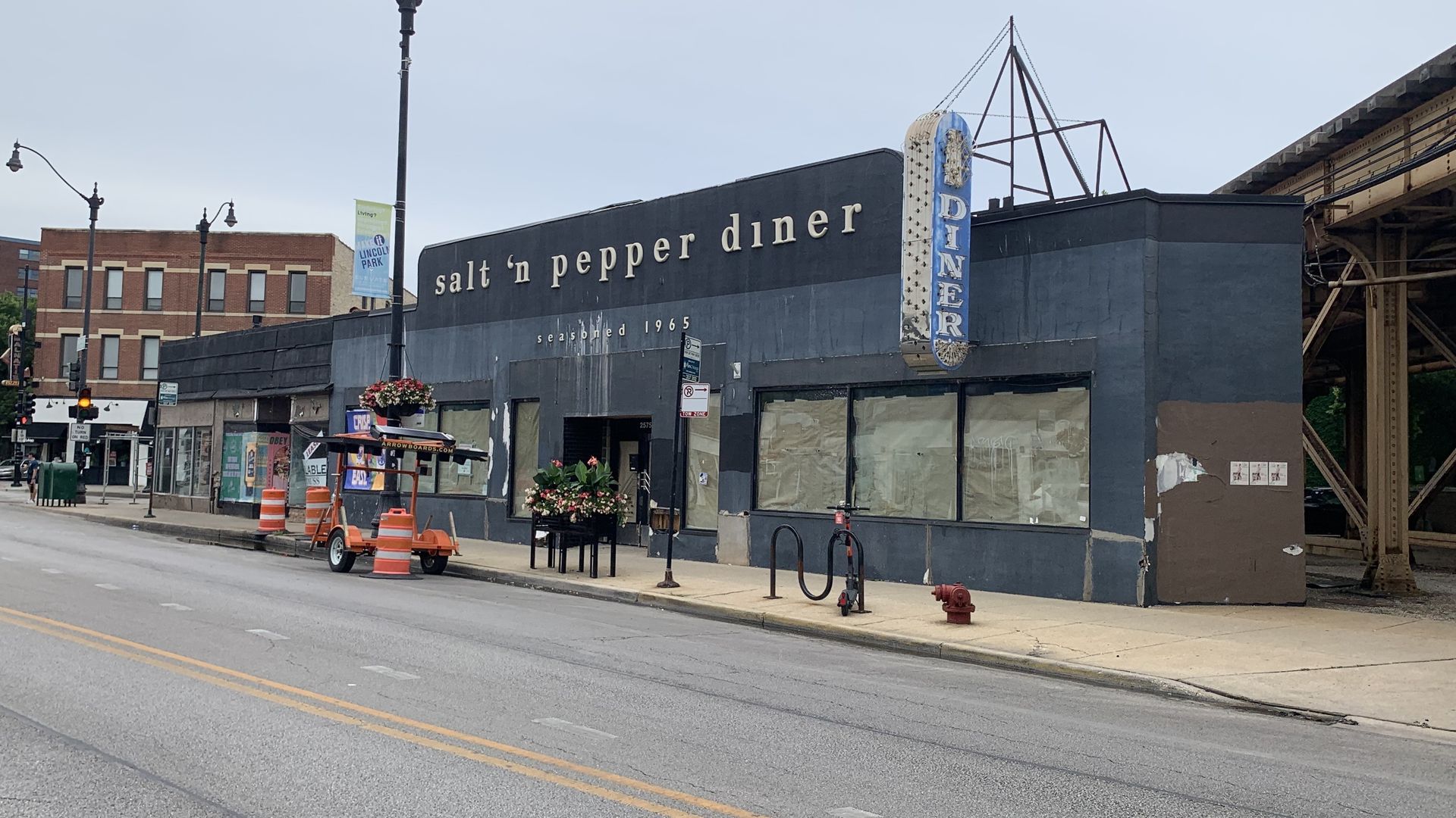 Gray building with brown paper in the windows.