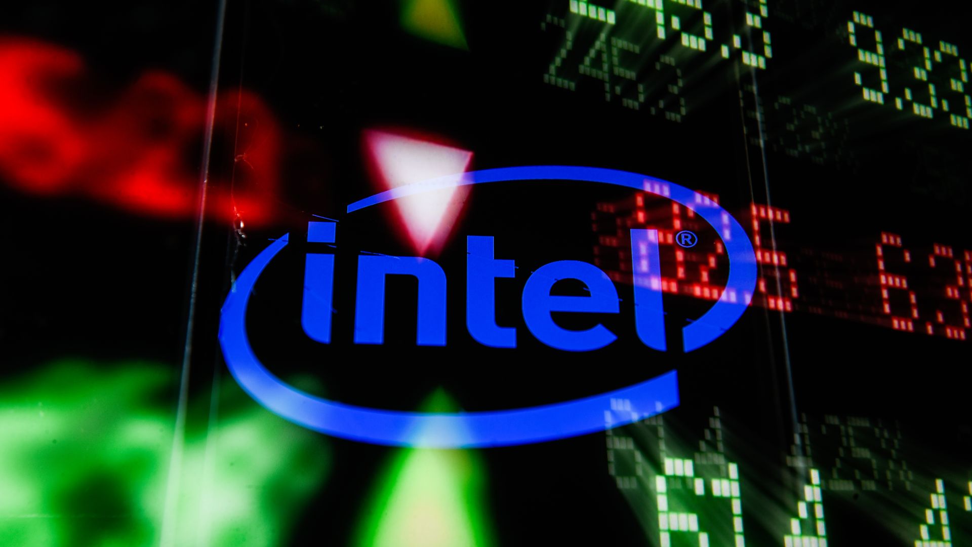 The intel logo is depicted on a screen, superimposed over various stock prices