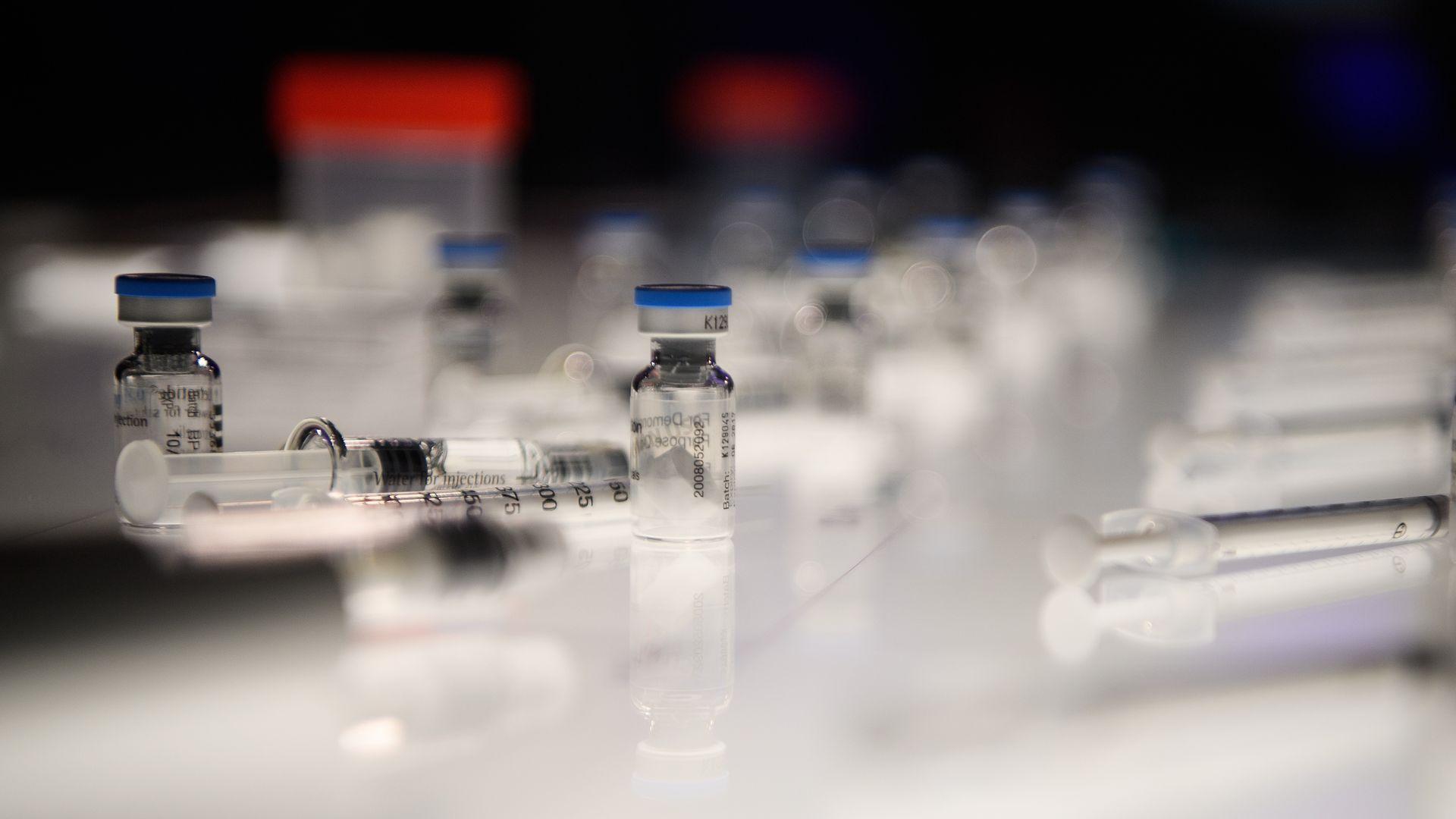 A selection of IVF hormone bottles and syringes