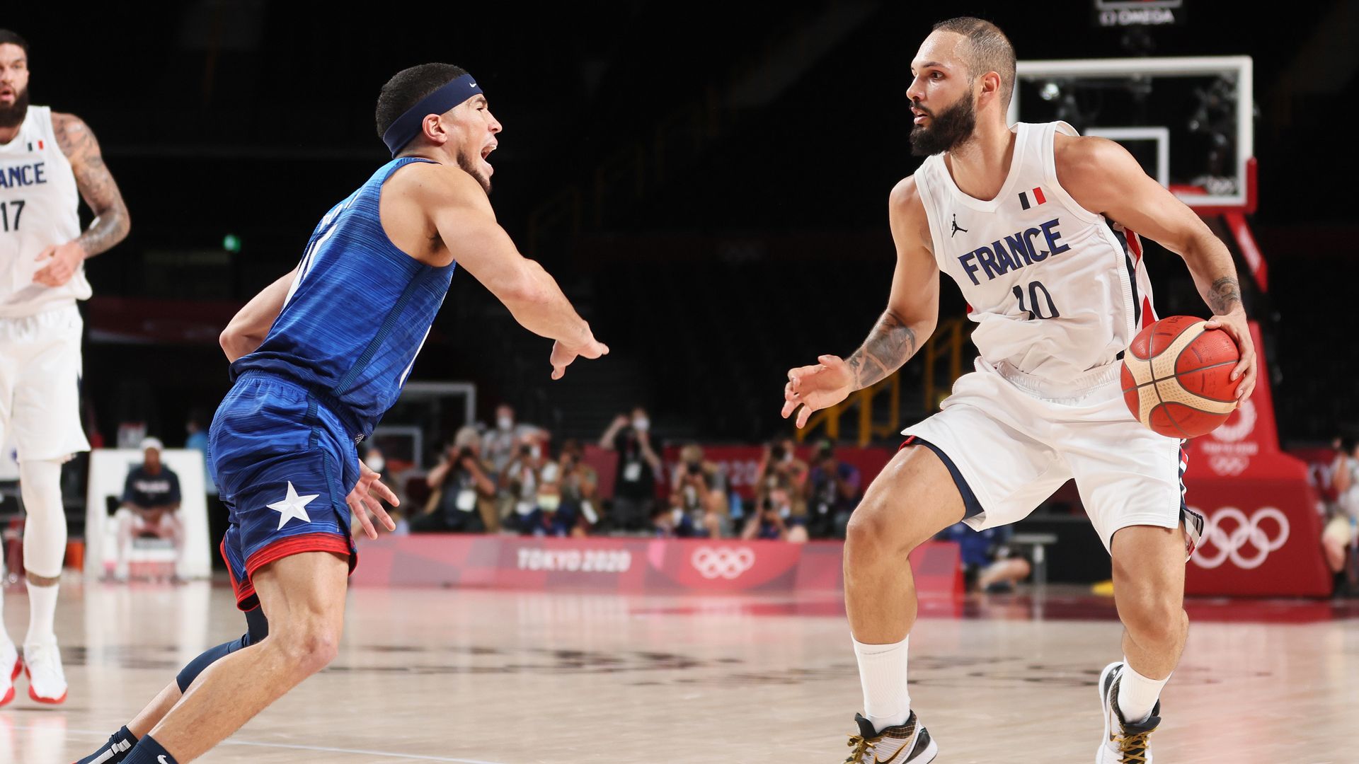Evan Fournier #10 of Team France looks to drive past Devin Booker #15 of Team United States 