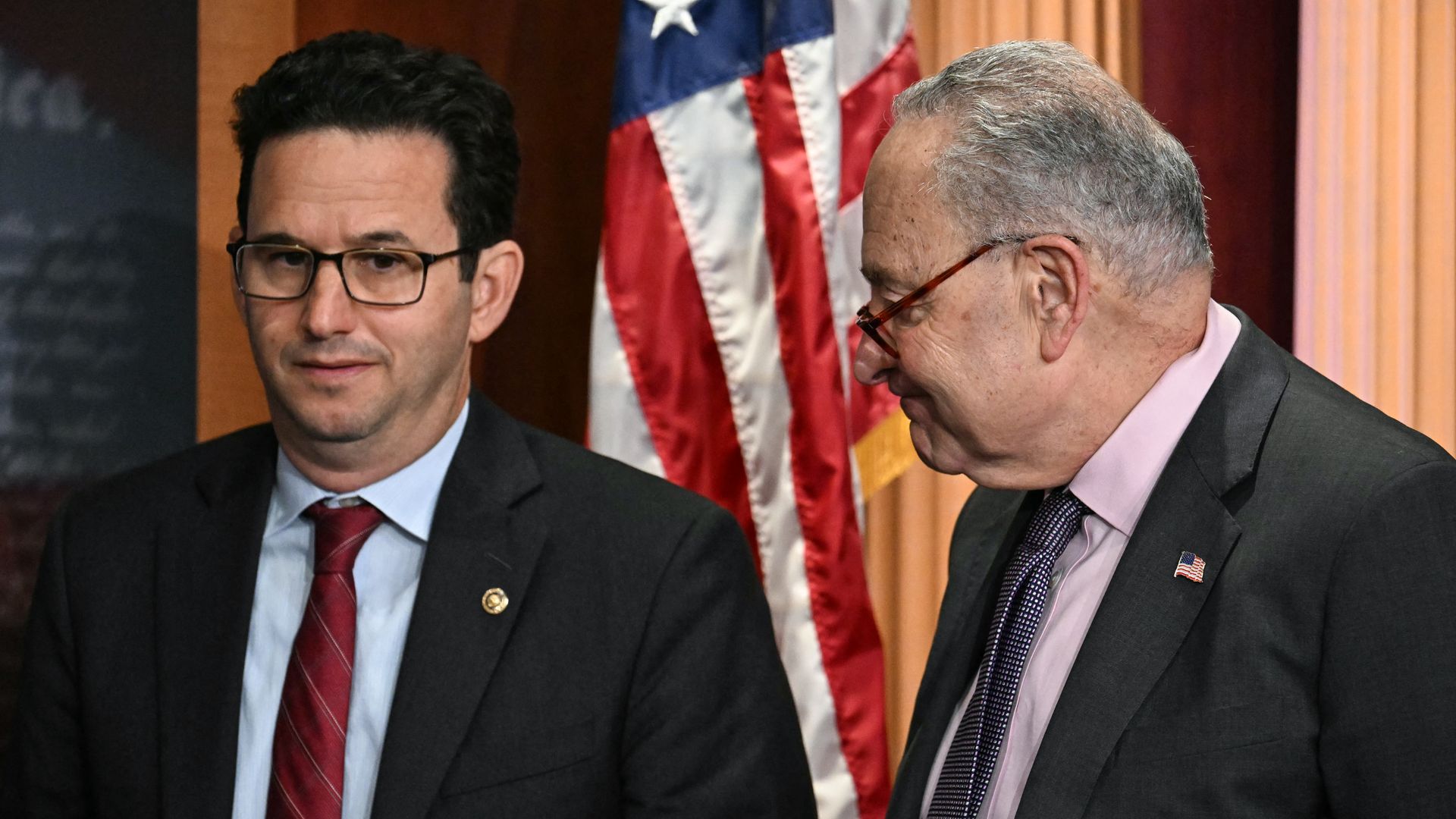 US Senator Brian Schatz, Democrat from Hawaii, and Senate Minority Leader Chuck Schumer, Democrat from New York, attend a news conference with Democratic Senators about protecting Social Security benefits for Americans, at the US Capitol on April 1, 2025, in Washington, DC.