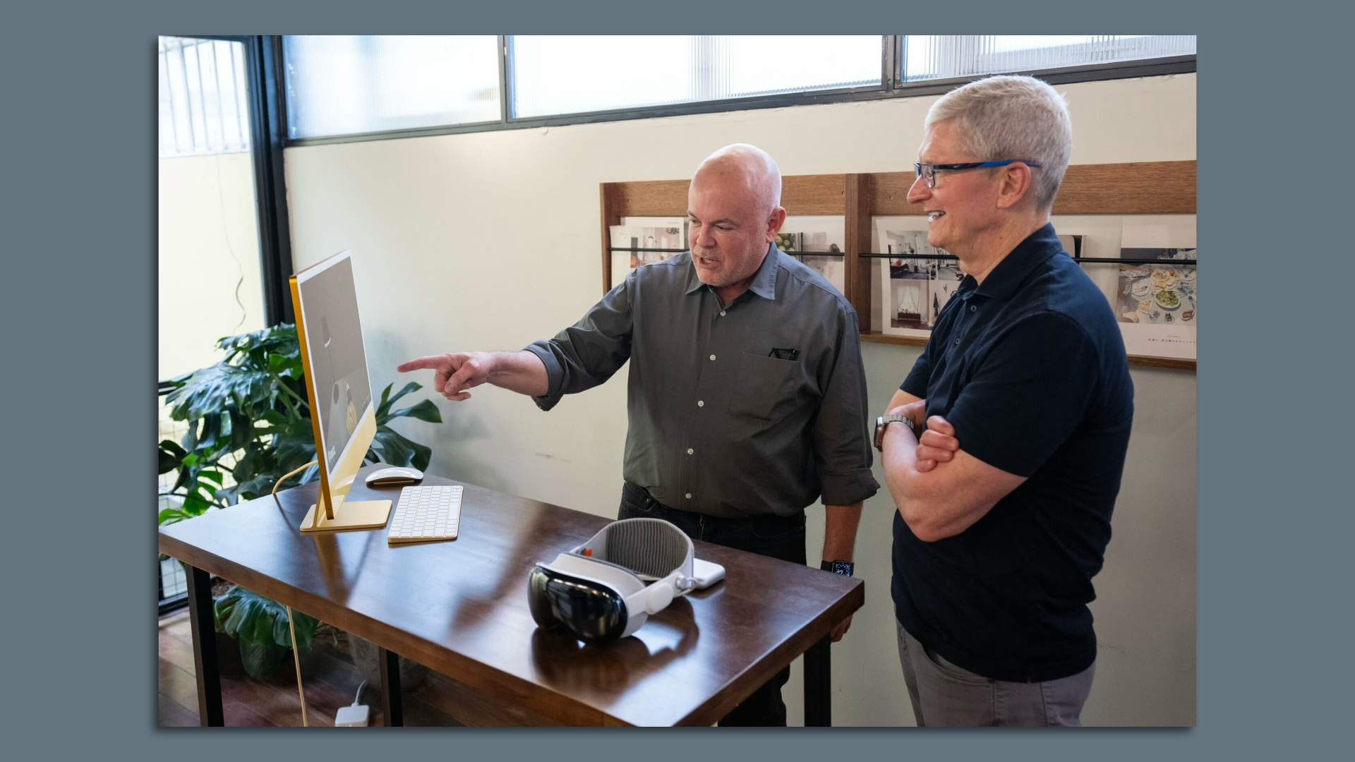 Tim Cook and Brian Pelz, Bootloader's founder and CEO looking at a demo on a computer monitor