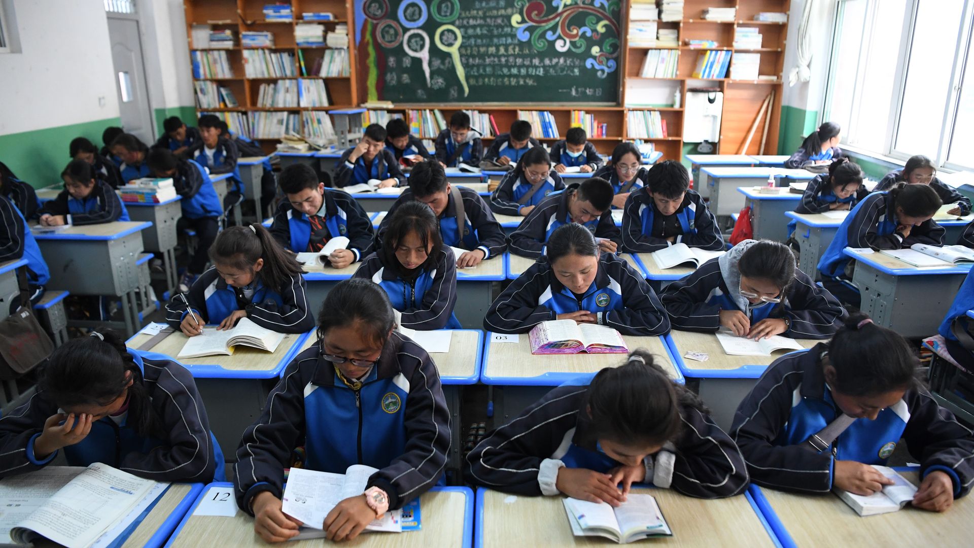 Students read books in a classroom at a middle school in Gansu province.