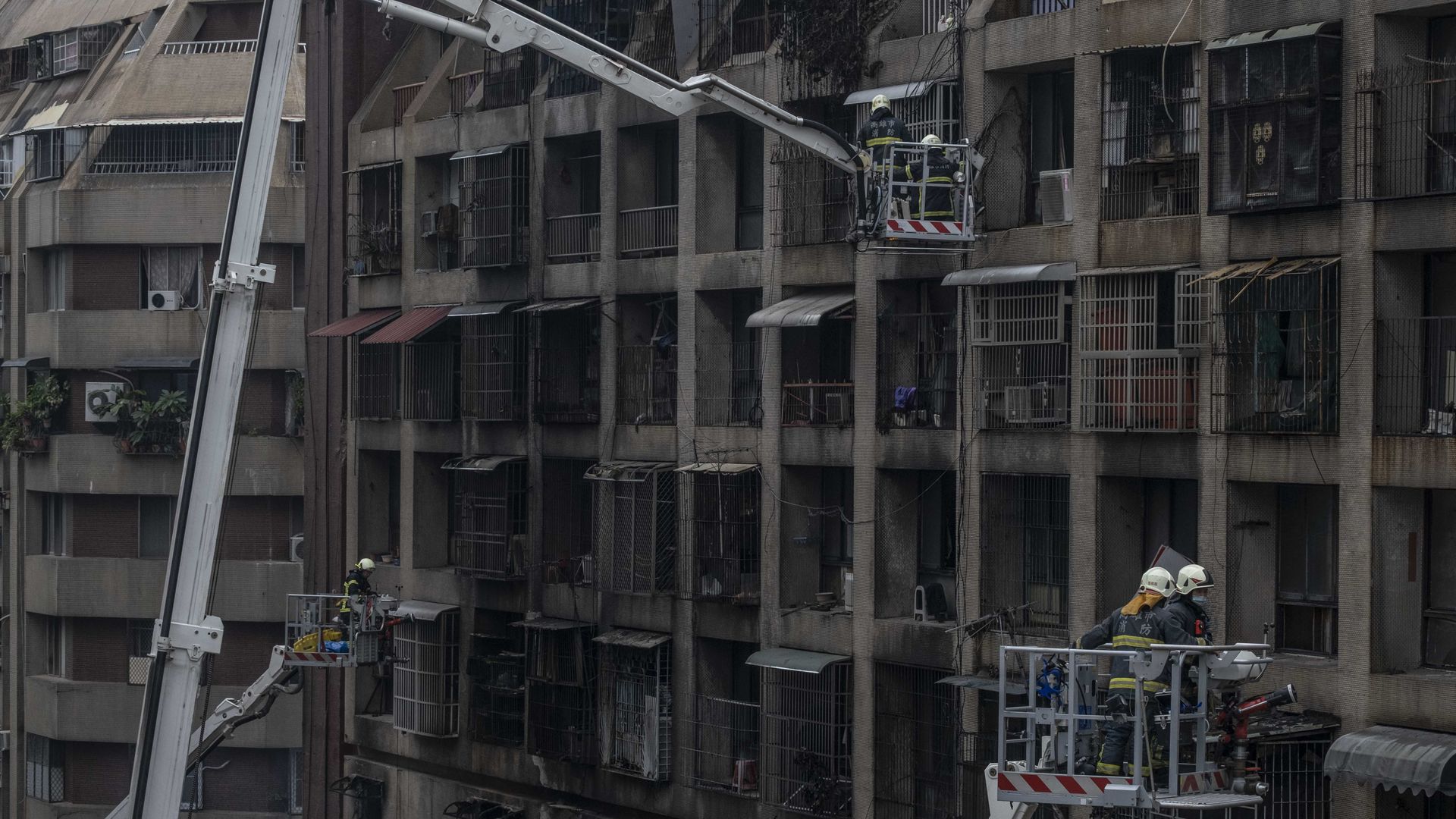 Firefighters searching for victims after a residential building caught fire in Kaohsiung, Taiwan, on Oct. 14.