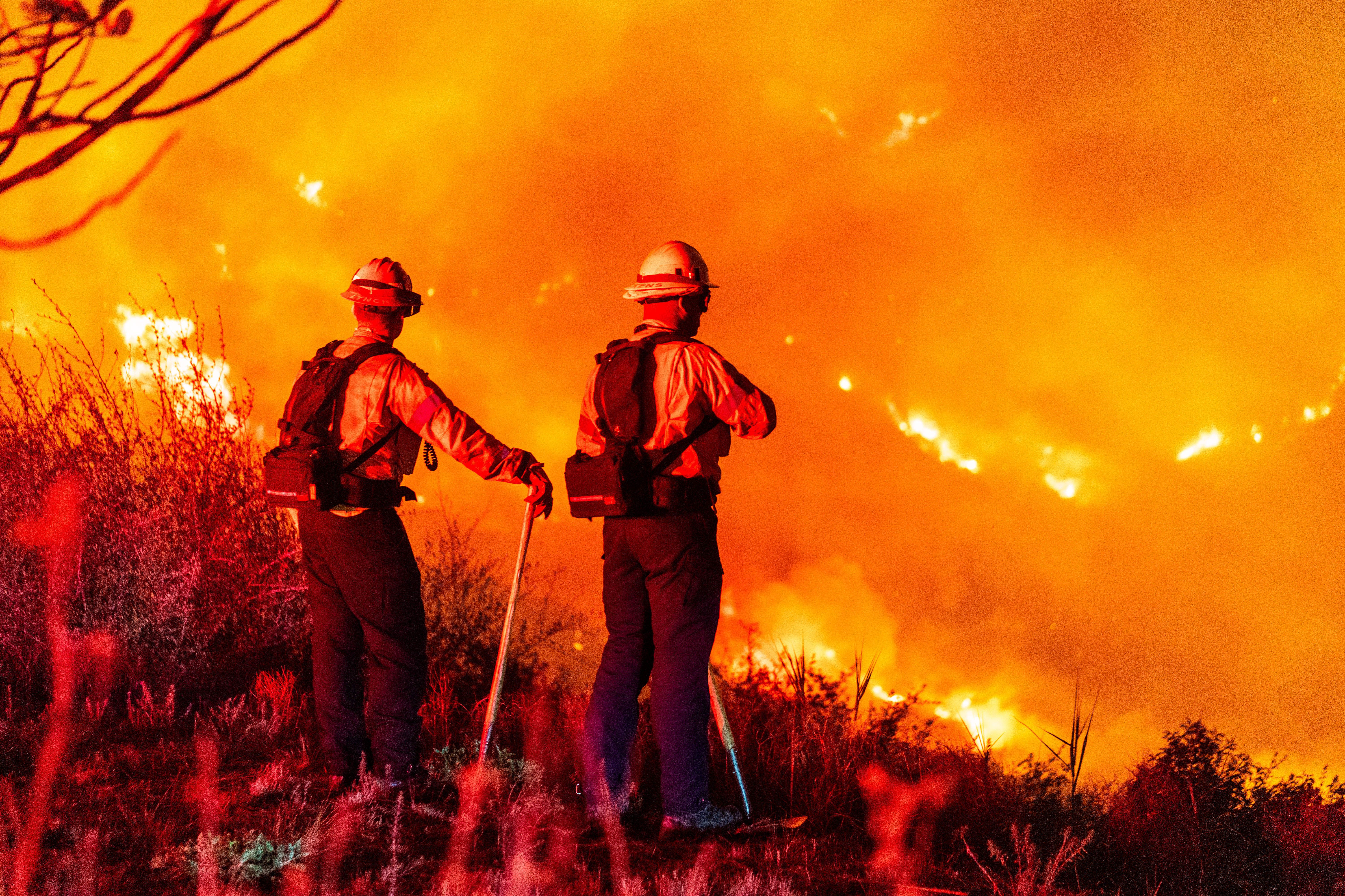 Firefighters monitor a burning hillside around Pepperdine University during the Franklin fire in Malibu, California, US, on Tuesday, Dec. 10, 2024. Hundreds of firefighters are racing to control a fast-moving Southern California wildfire that's threatening the wealthy town of Malibu and has forced t