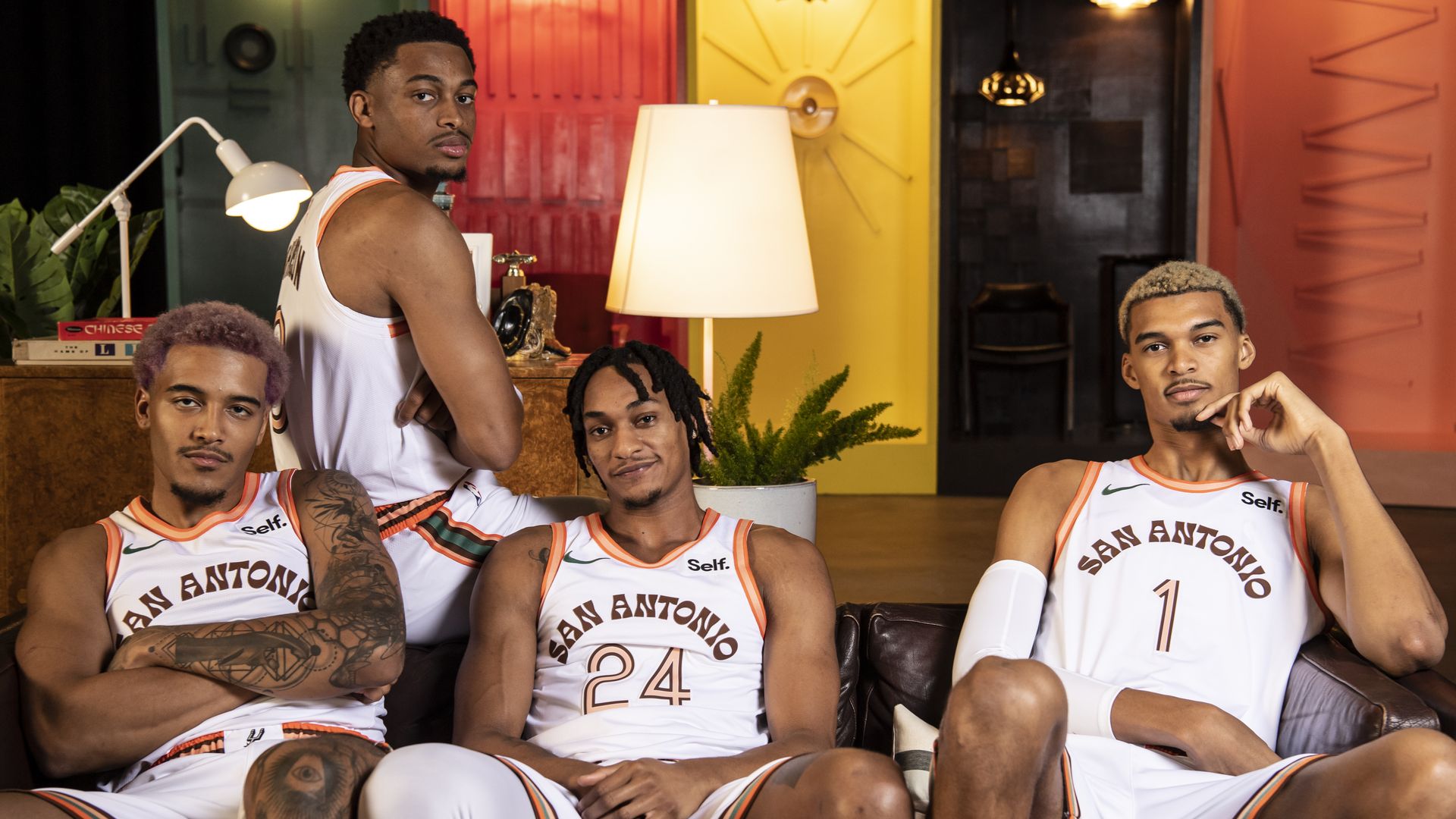 Jeremy Sochan, Keldon Johnson, Devin Vassell and Victor Wembanyama sport the Spurs' new City Edition uniforms, which are white with orange and brown accents.