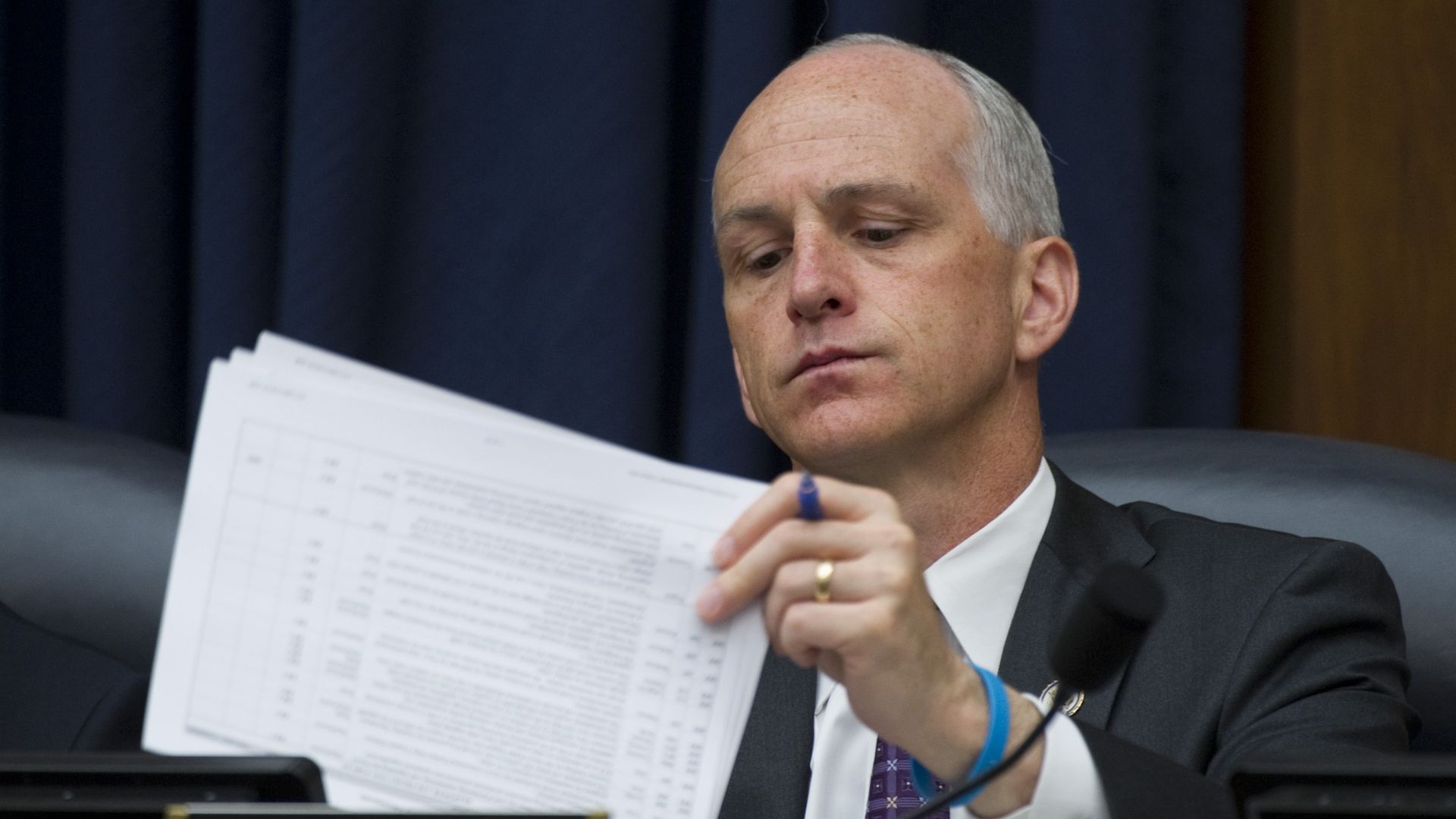 House Armed Services Committee Chairman Adam Smith is seen reviewing some papers.