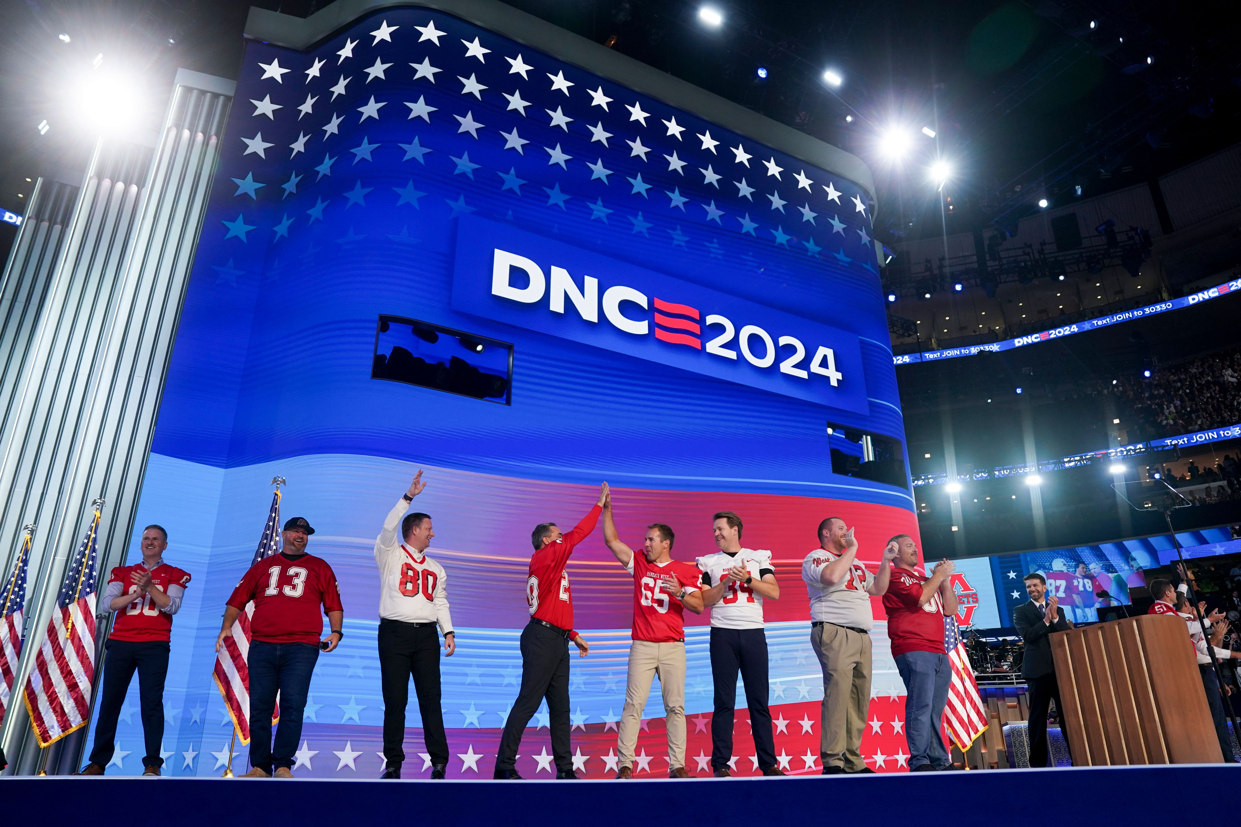 Former members of the Mankato West High School football team — coached by Walz — appear at the DNC.