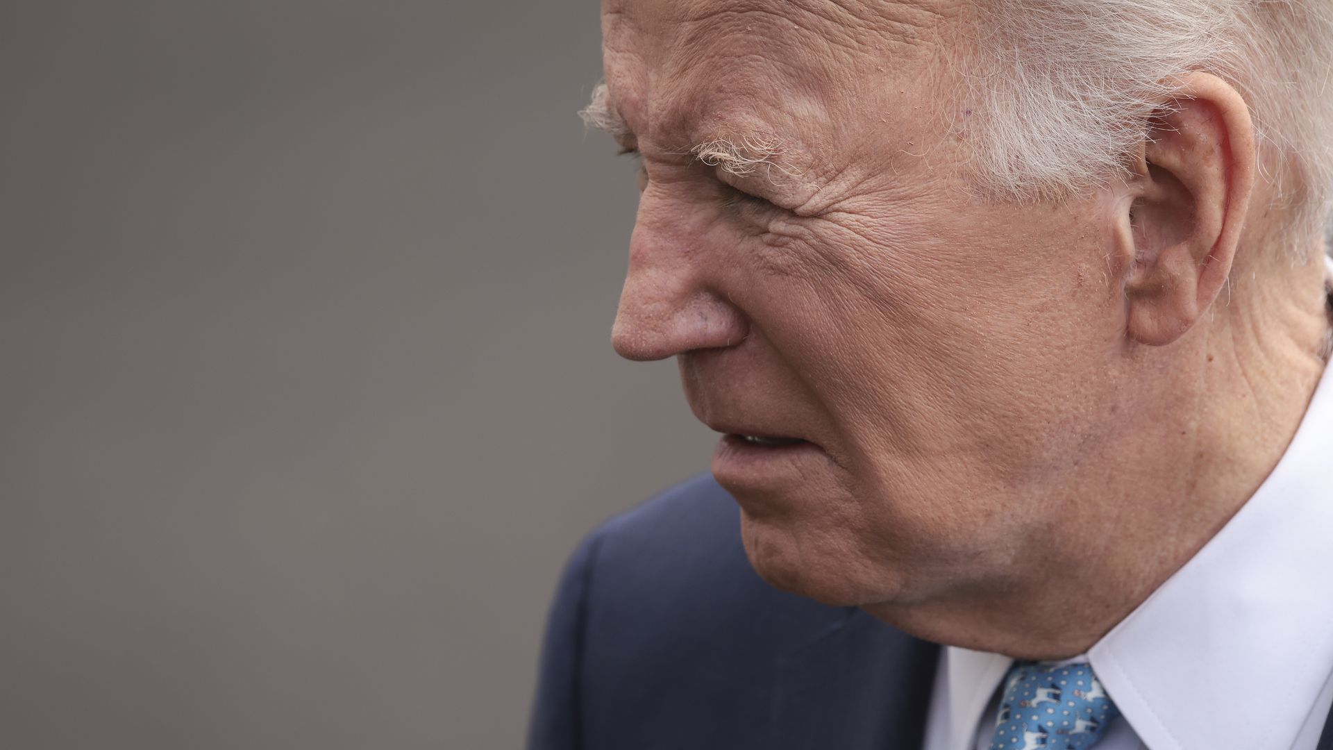 A close-up of President Biden's face, shown from the side.