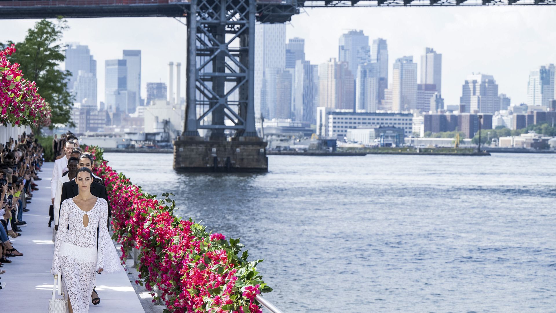 models walking alongside East River during New York Fashion Week