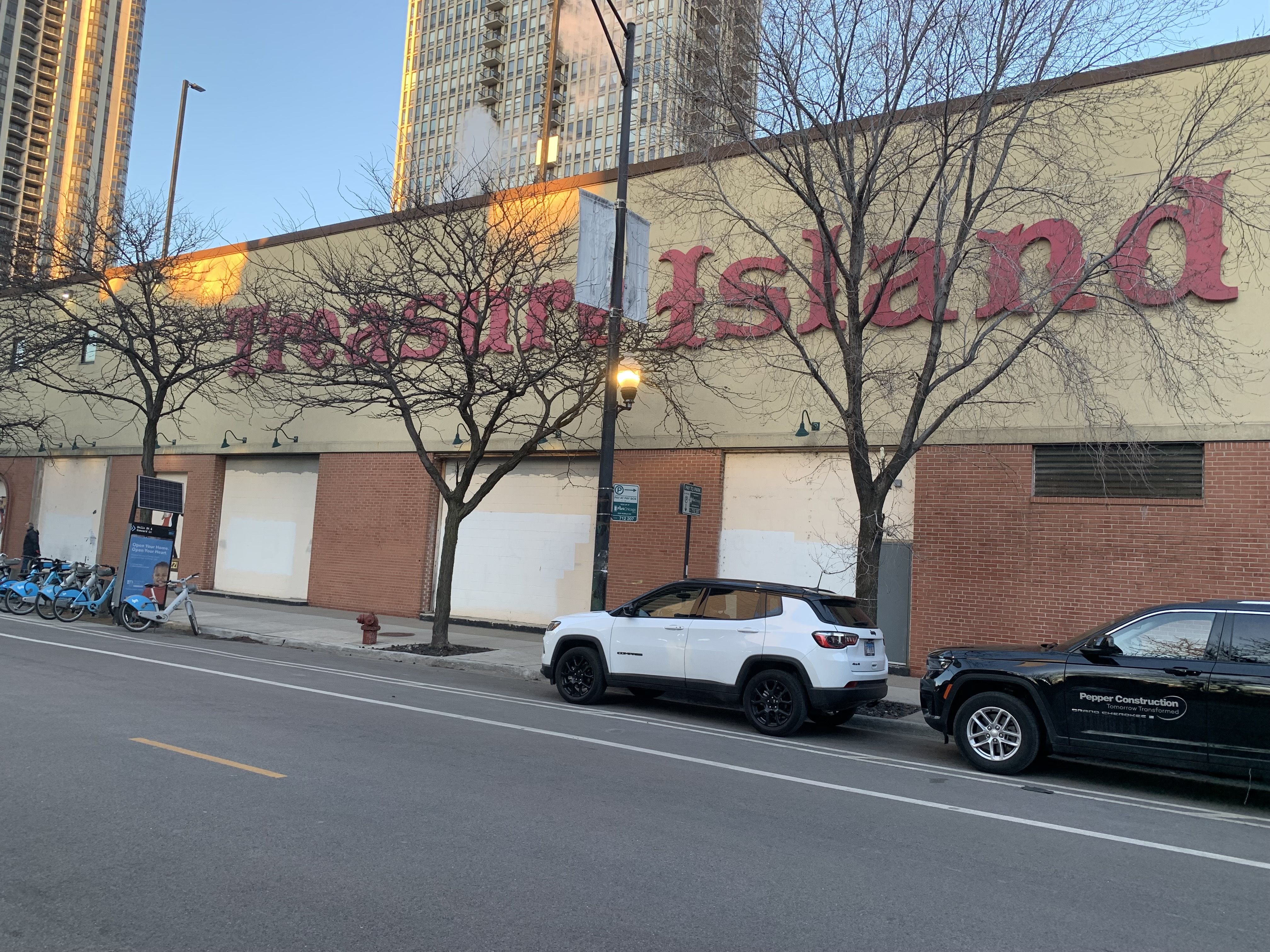Photo of a boarded up grocery store with a sign that says Treasure Island
