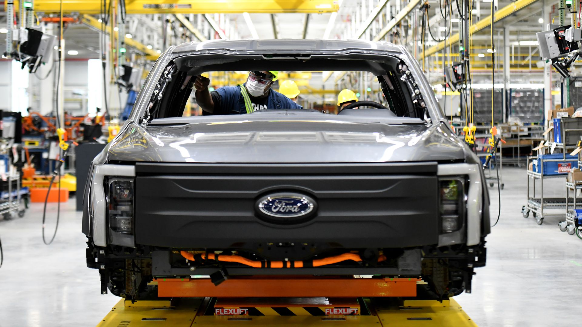 Image of a factory employee working on the Ford F-150 Lightning electric pickup truck