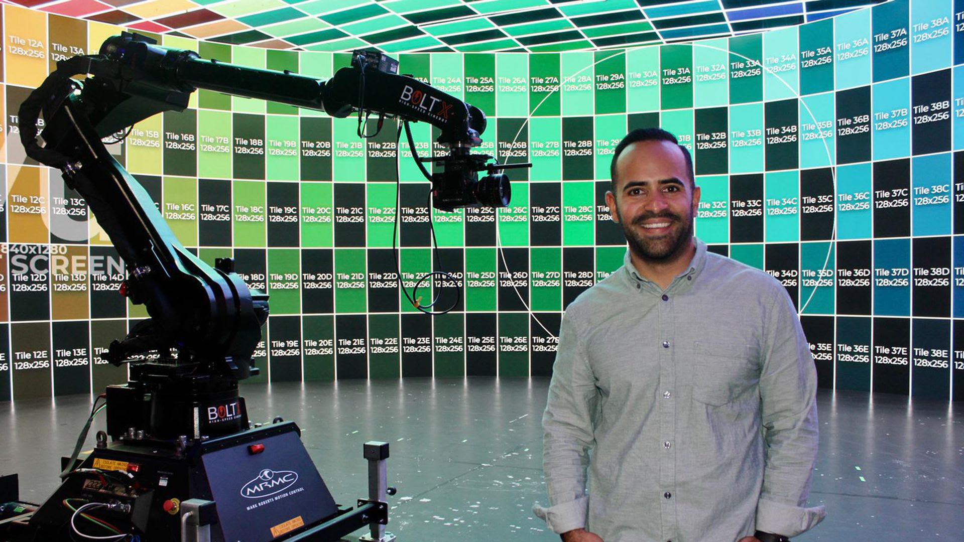 Founder Jonathan Davila stands in front of the Vū Studio production screen. 