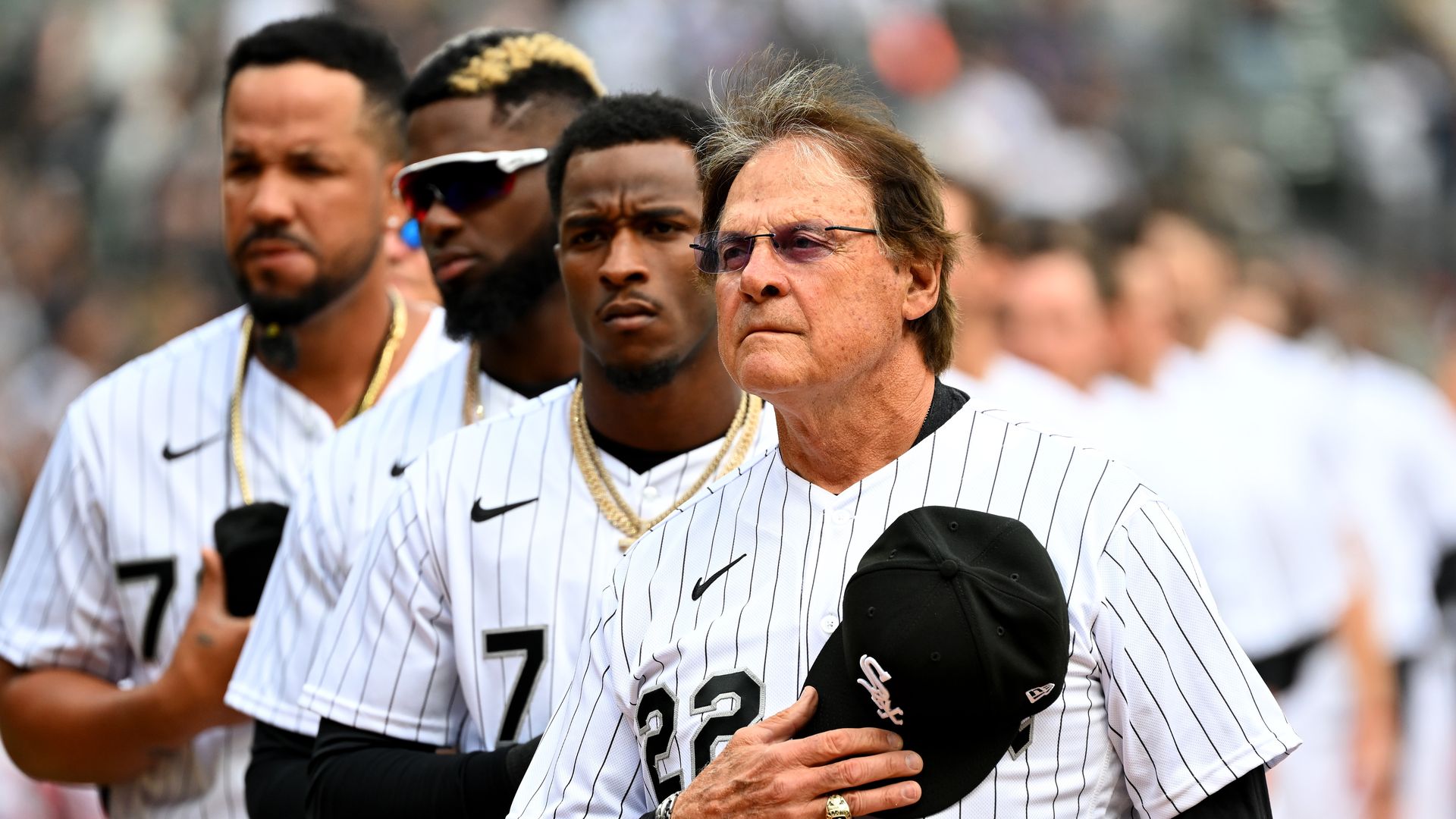 Baseball players with their hats off during anthem