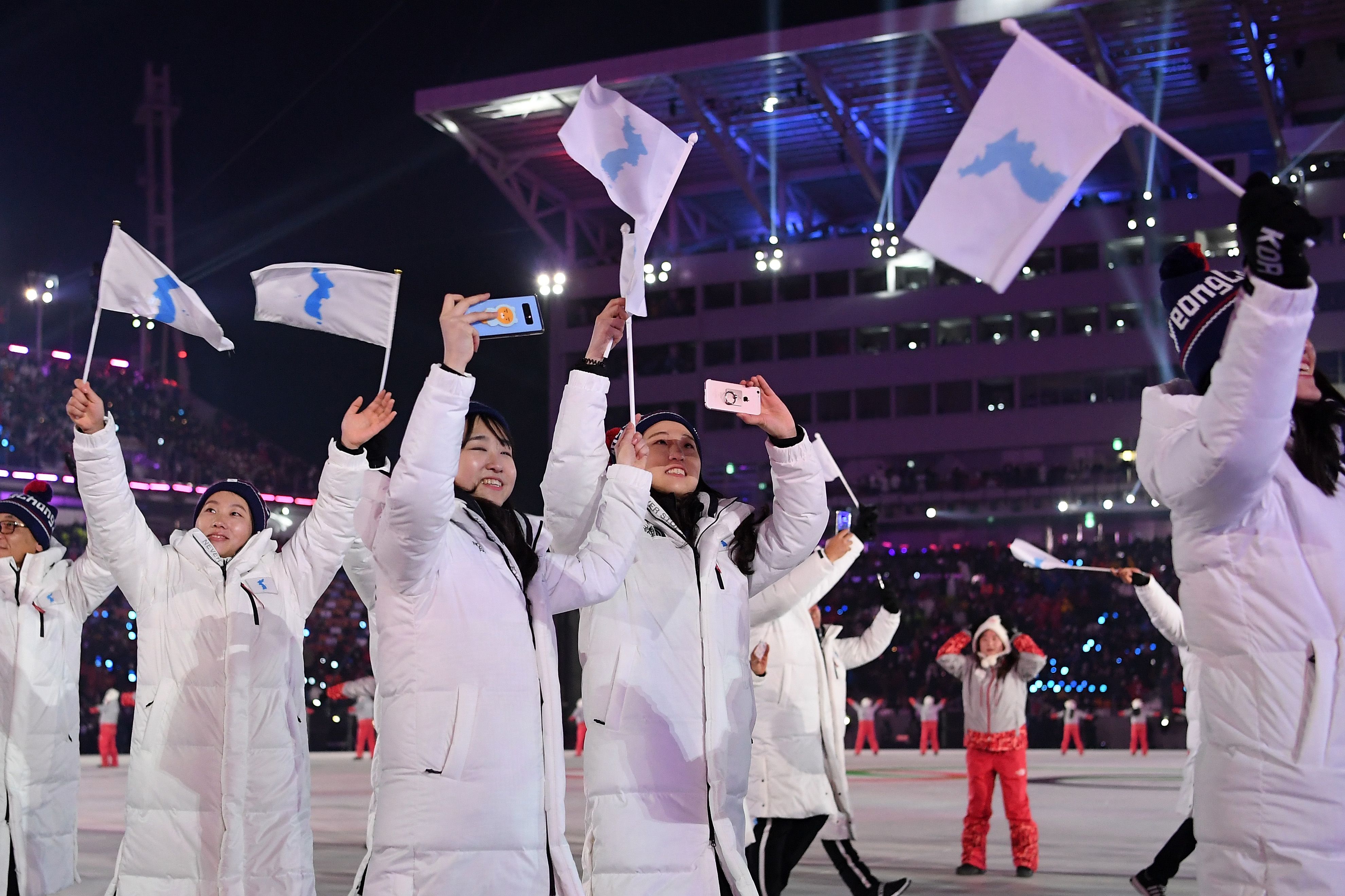 South and North Koreans walk together at the Opening Ceremony wearing all white.