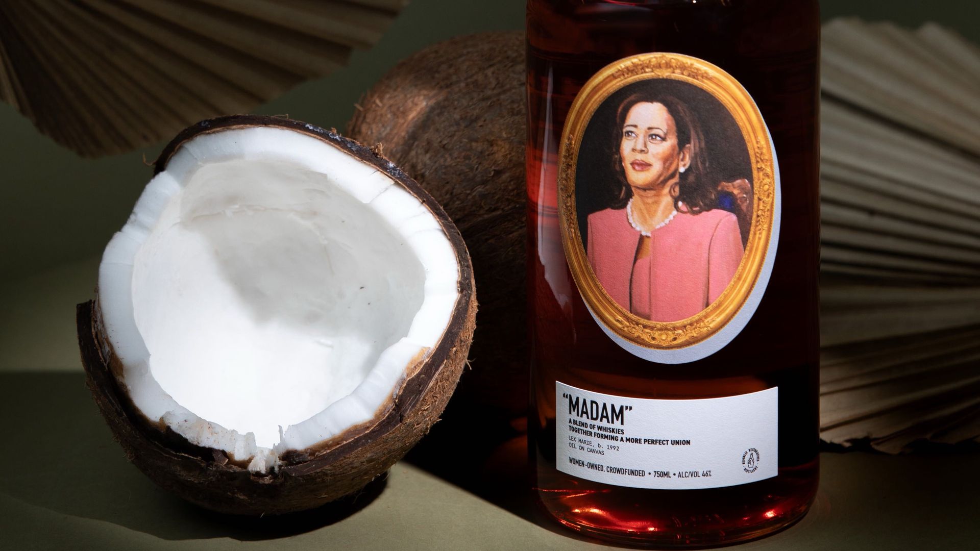 A bottle of Madam whiskey next to a coconut.