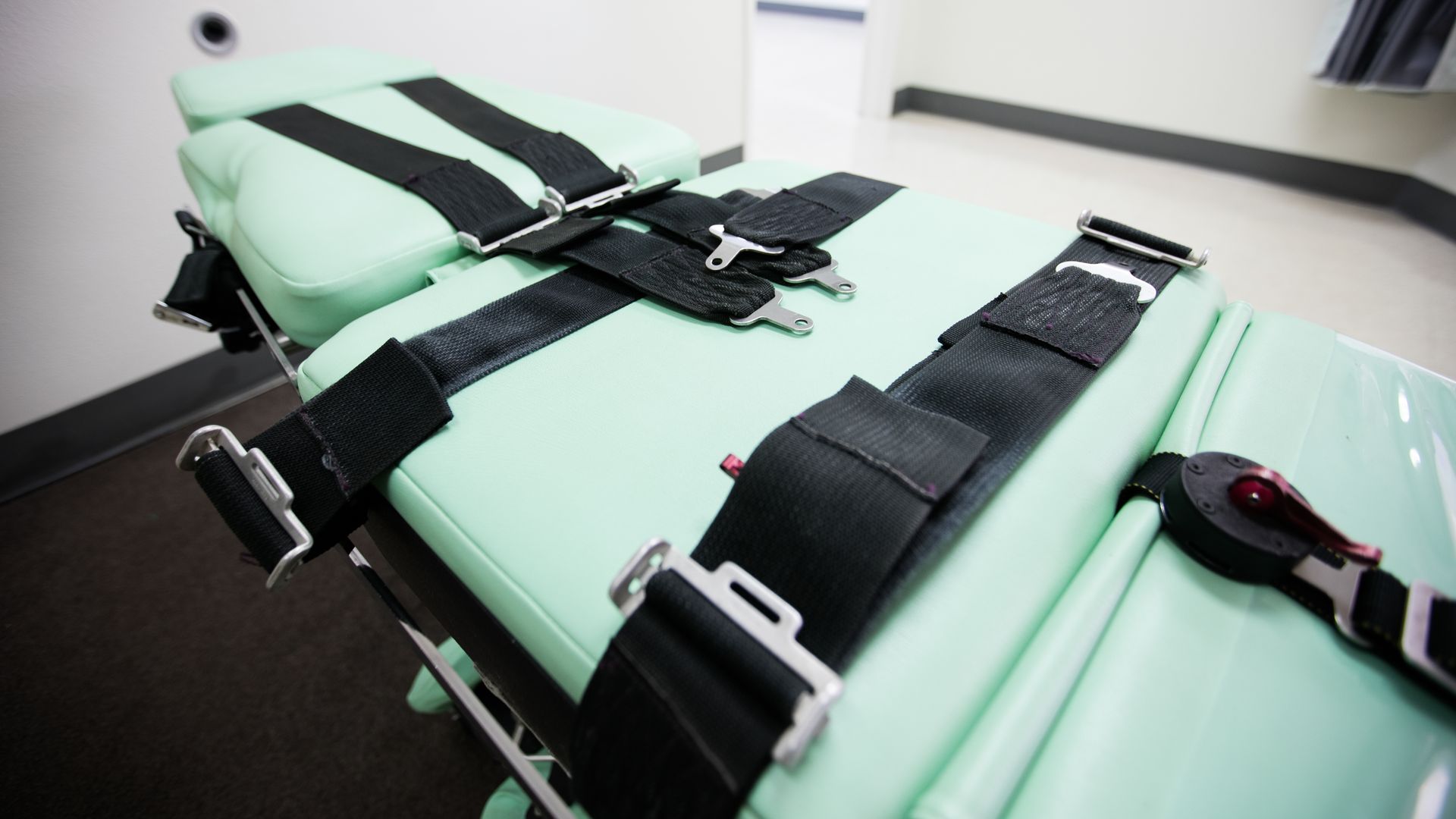 An execution table in a prison covered in black straps used to hold condemned prisoners. 