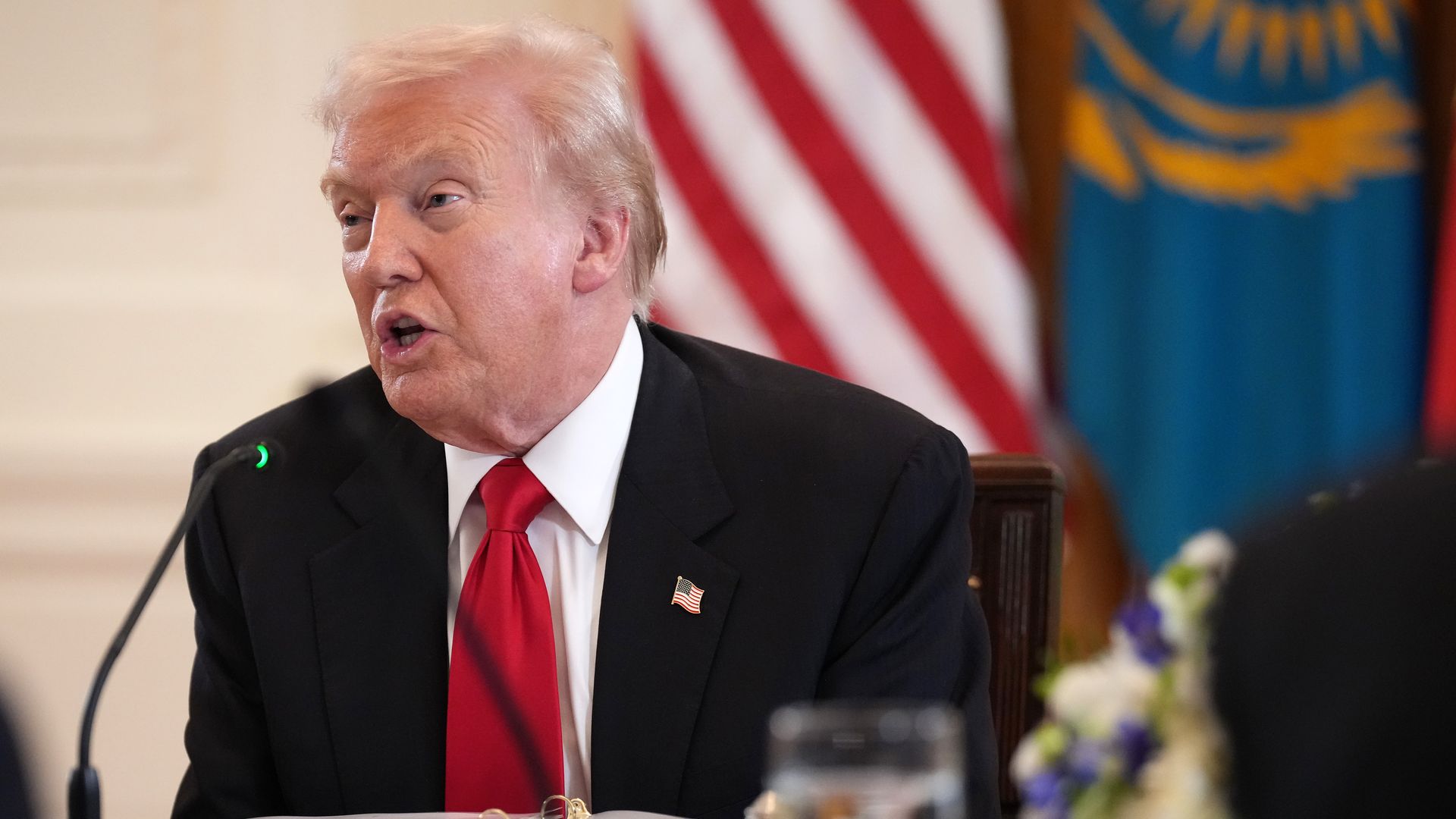 President Trump seated and speaking at a White House dinner.