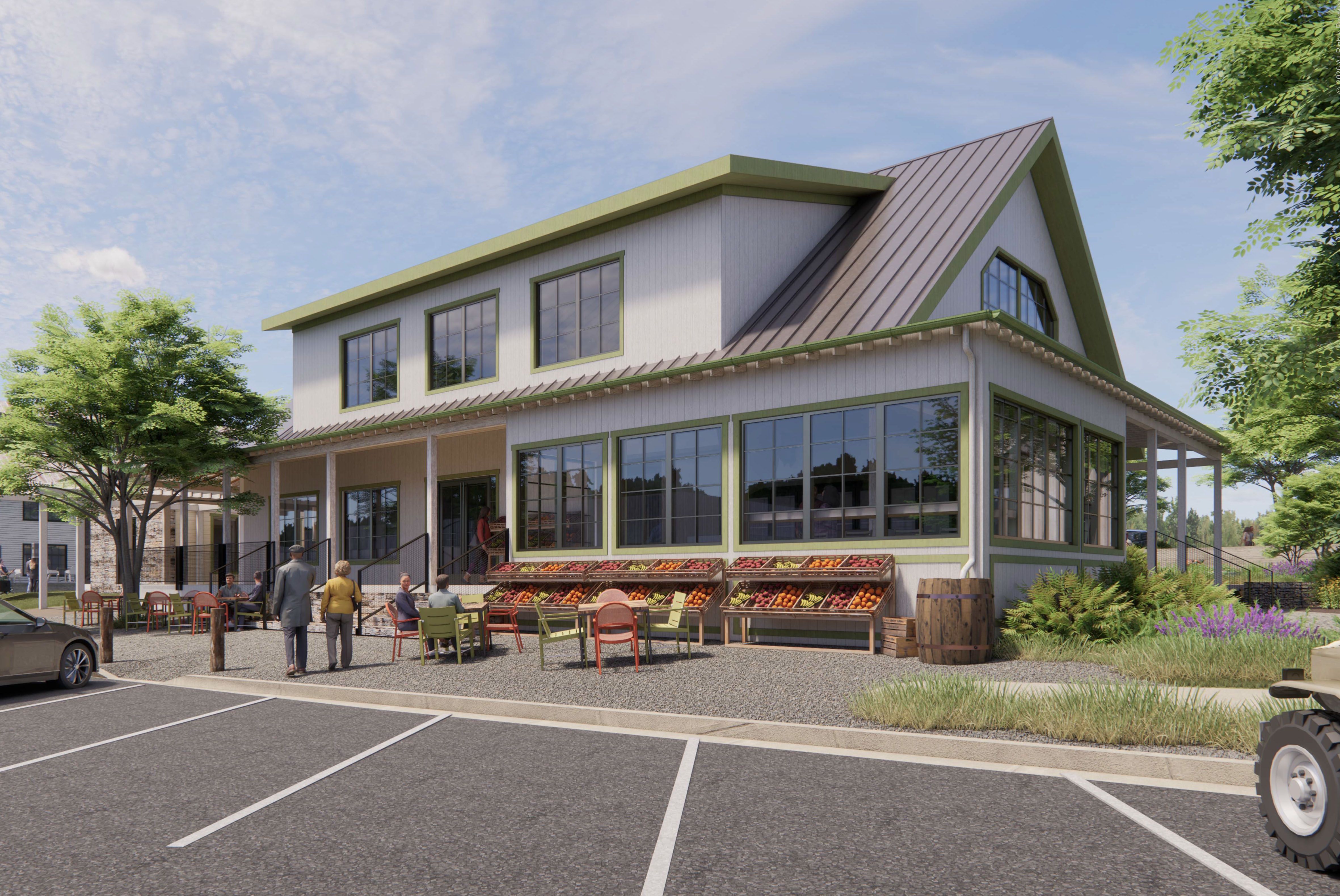 Two-story market building with green trim and metal gable roof, large windows, and an outdoor seating area. Crates of produce line the front; people mingle near the entrance.