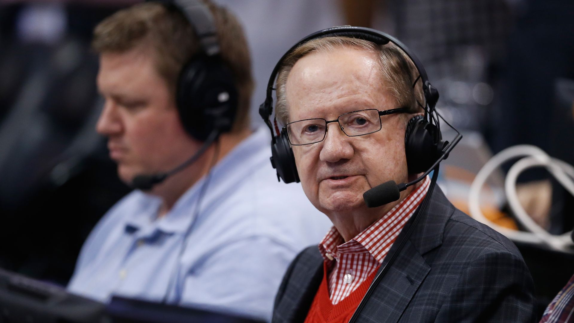 Al McCoy looks at the camera while announcing a Phoenix Suns game. 