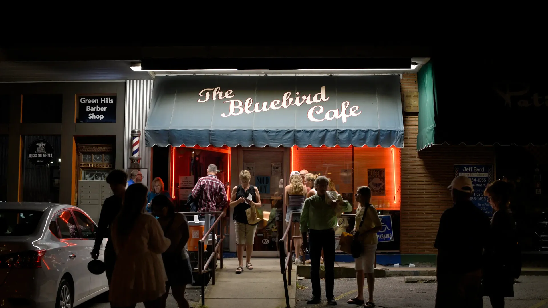 A line of fans standing outside the Bluebird Cafe.