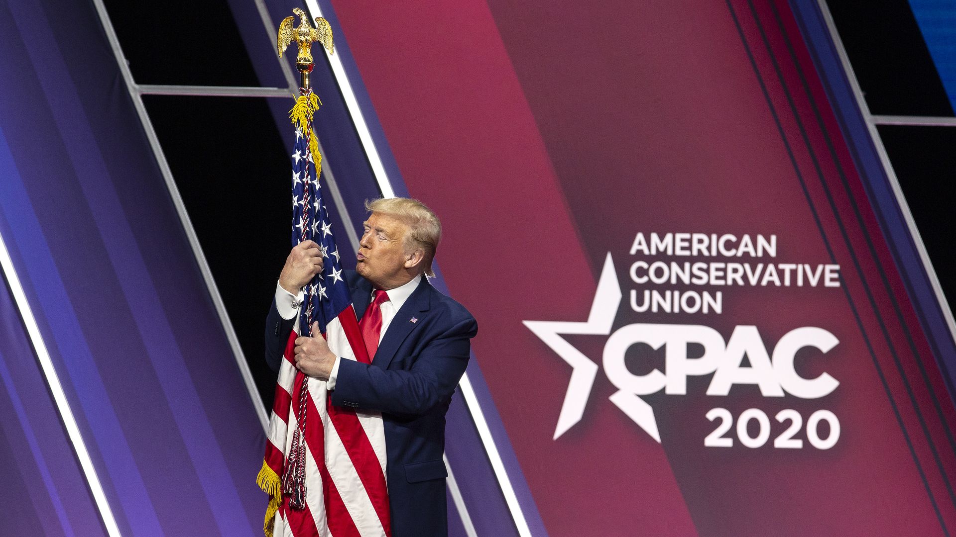 Former President Trump is seen hugging the American flag at last year's 2020 Conservative Political Action Conference.