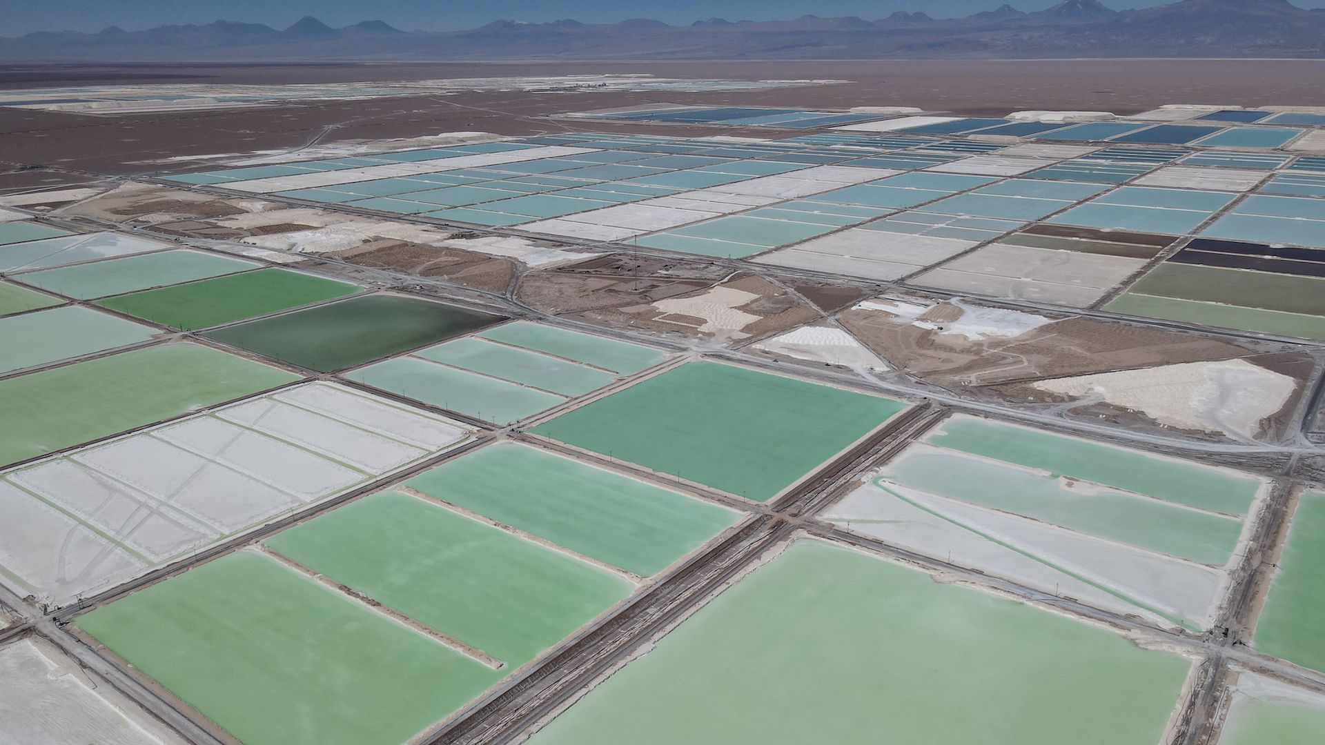  Pools of brine containing lithium carbonate and mounds of salt by-products stretch across a lithium mine in the Atacama Desert in Chile 
