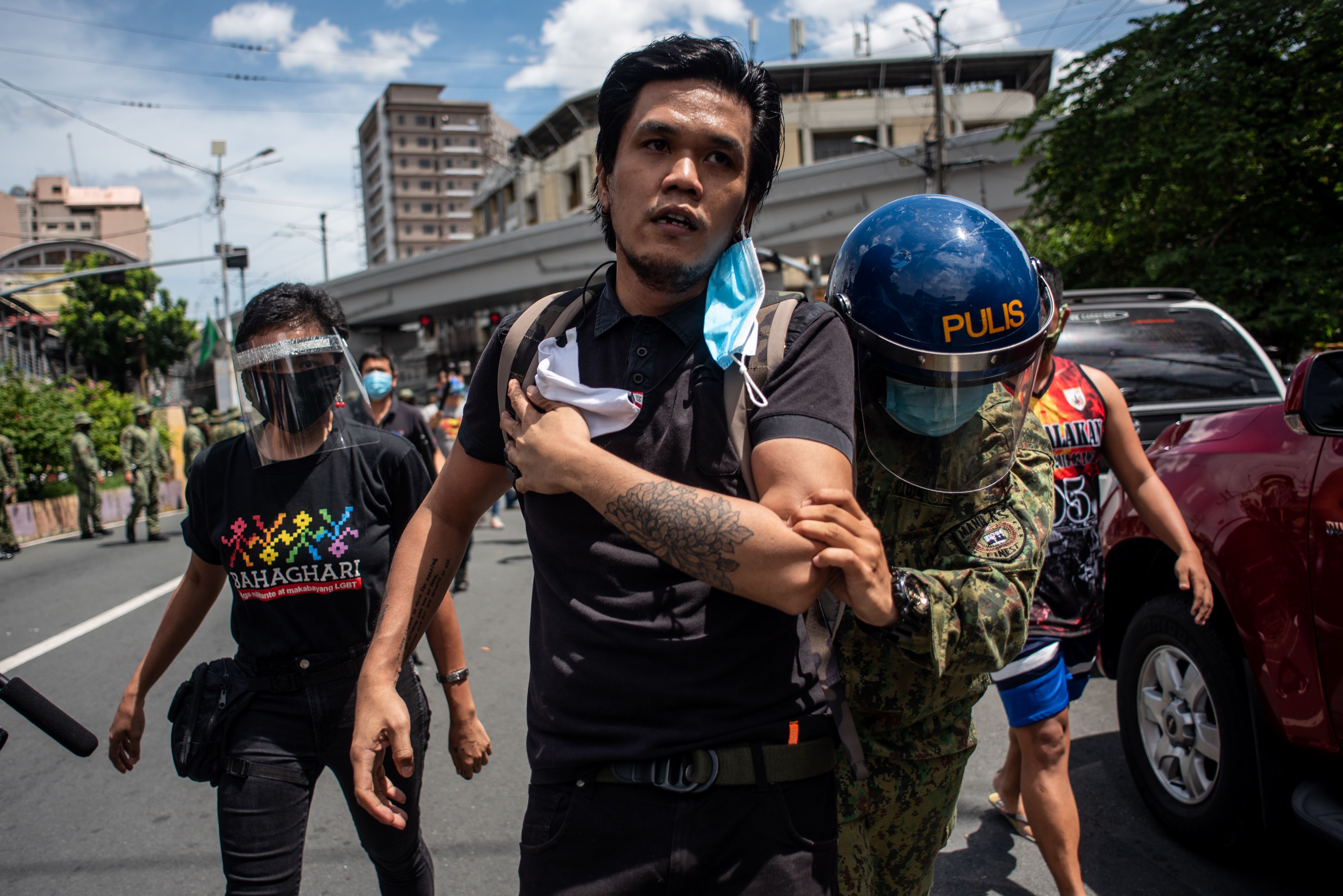 Police officers arrest a protestor during the Pride March Protest in Manila, Philippines on June 26