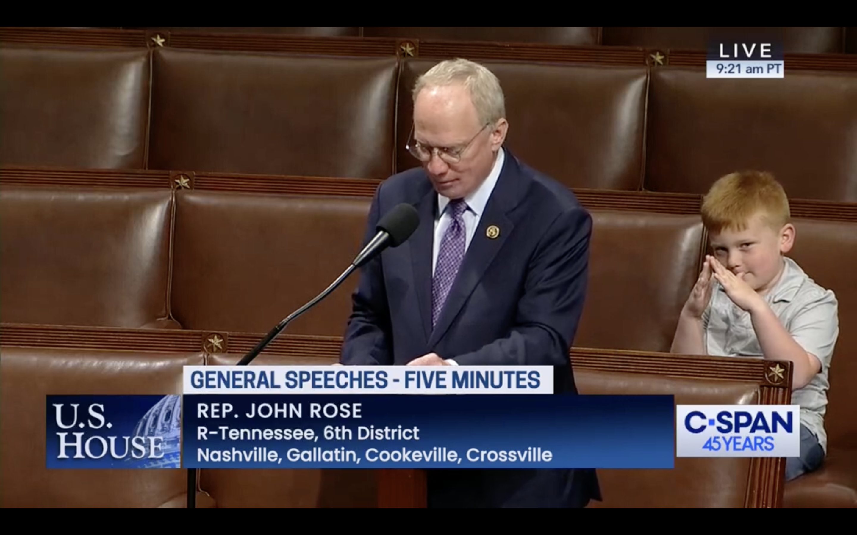 A child makes silly faces during a speech.