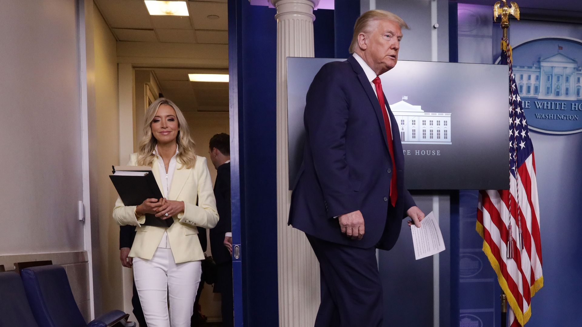 This image shows Trump and his press secretary before a White House briefing