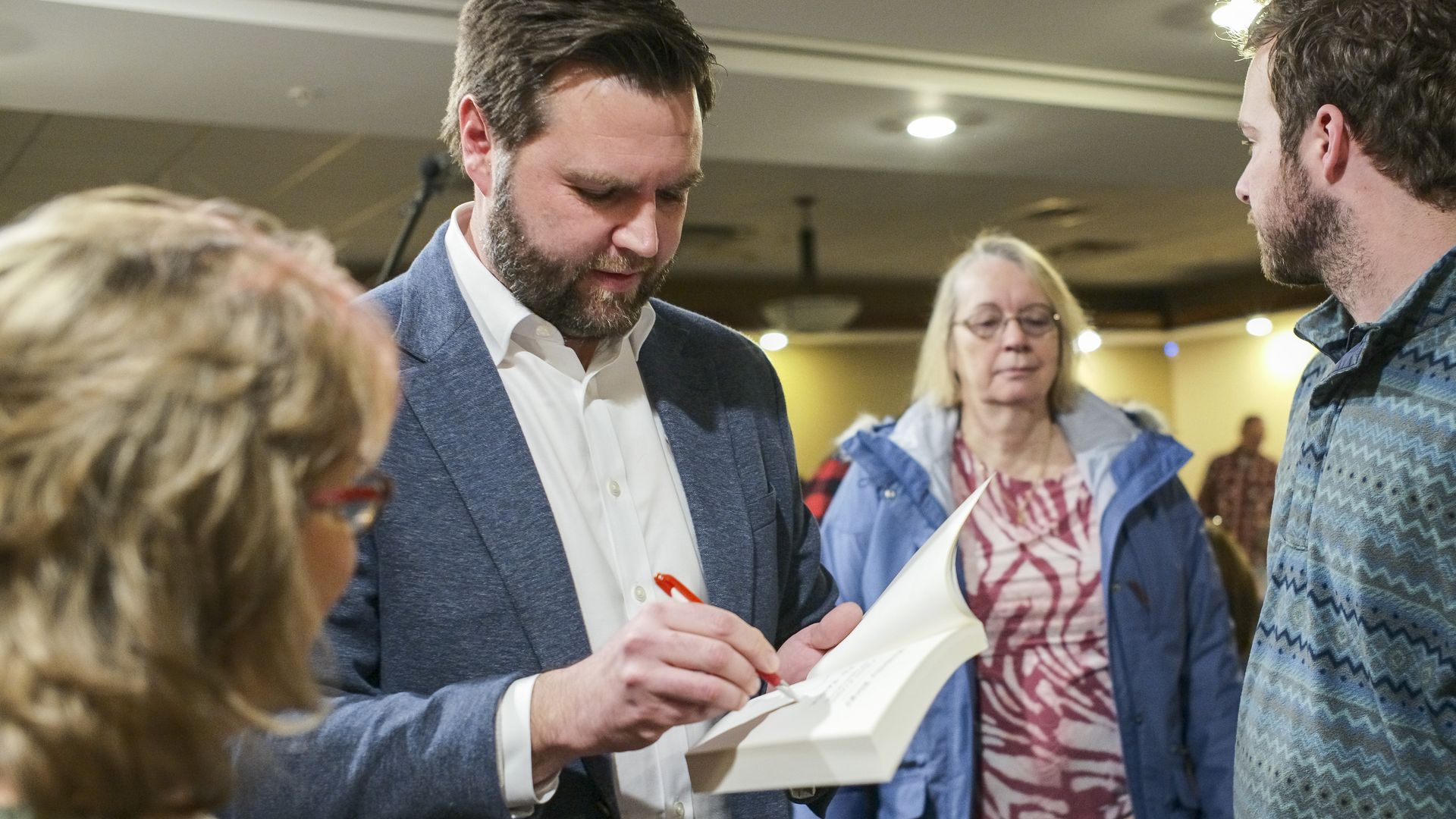 JD Vance photographed signing a copy of "Hillbilly Elegy"