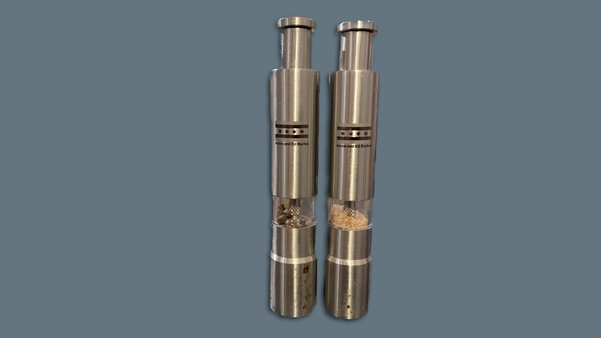 Thin, silver salt and pepper shakers with a Chicago flag on them.