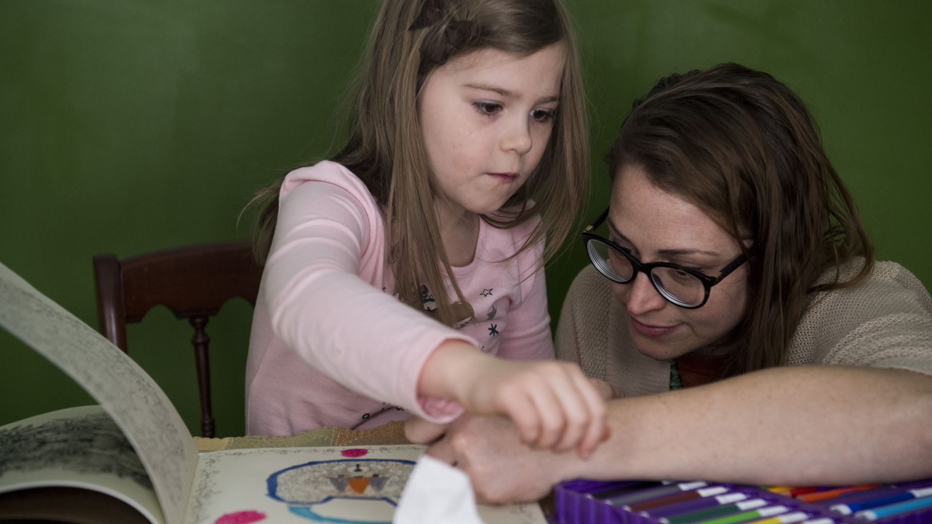 A mother on Medicaid in Kentucky plays with her daughter