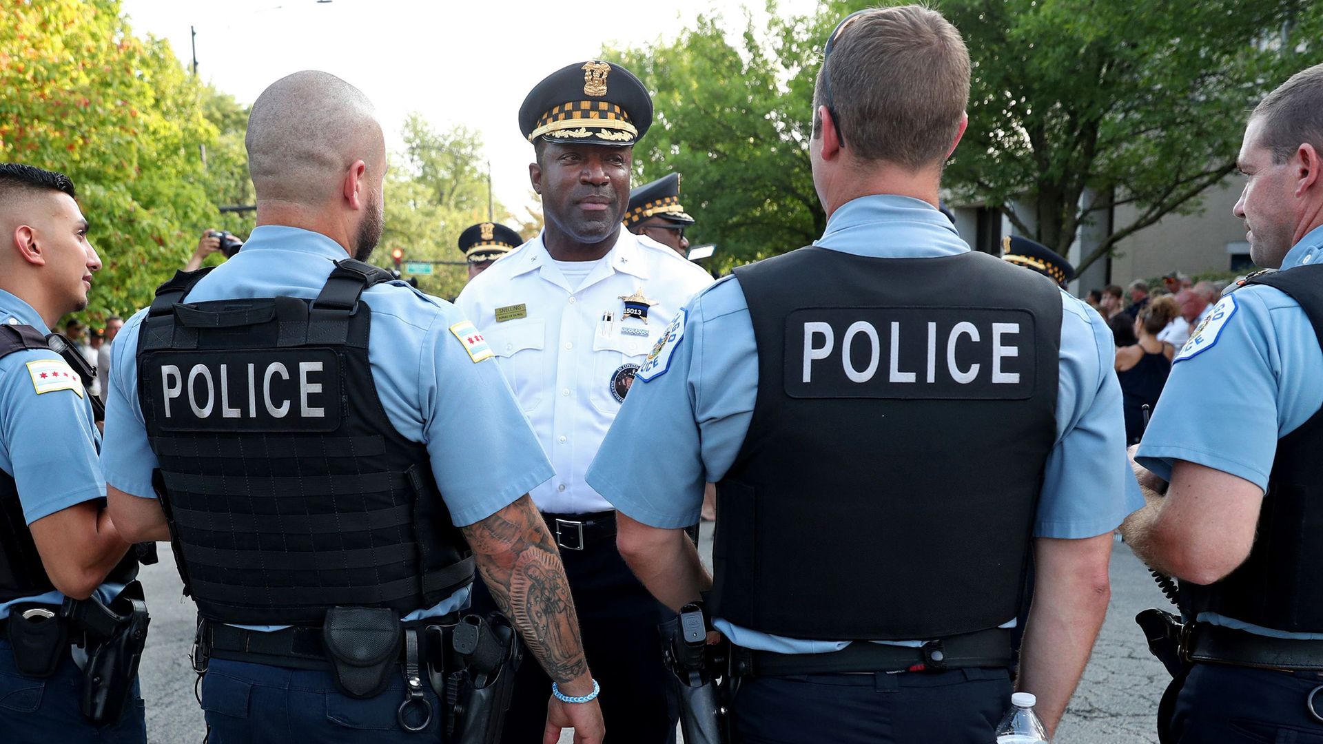 Larry Snelling speaks to police officers outside.