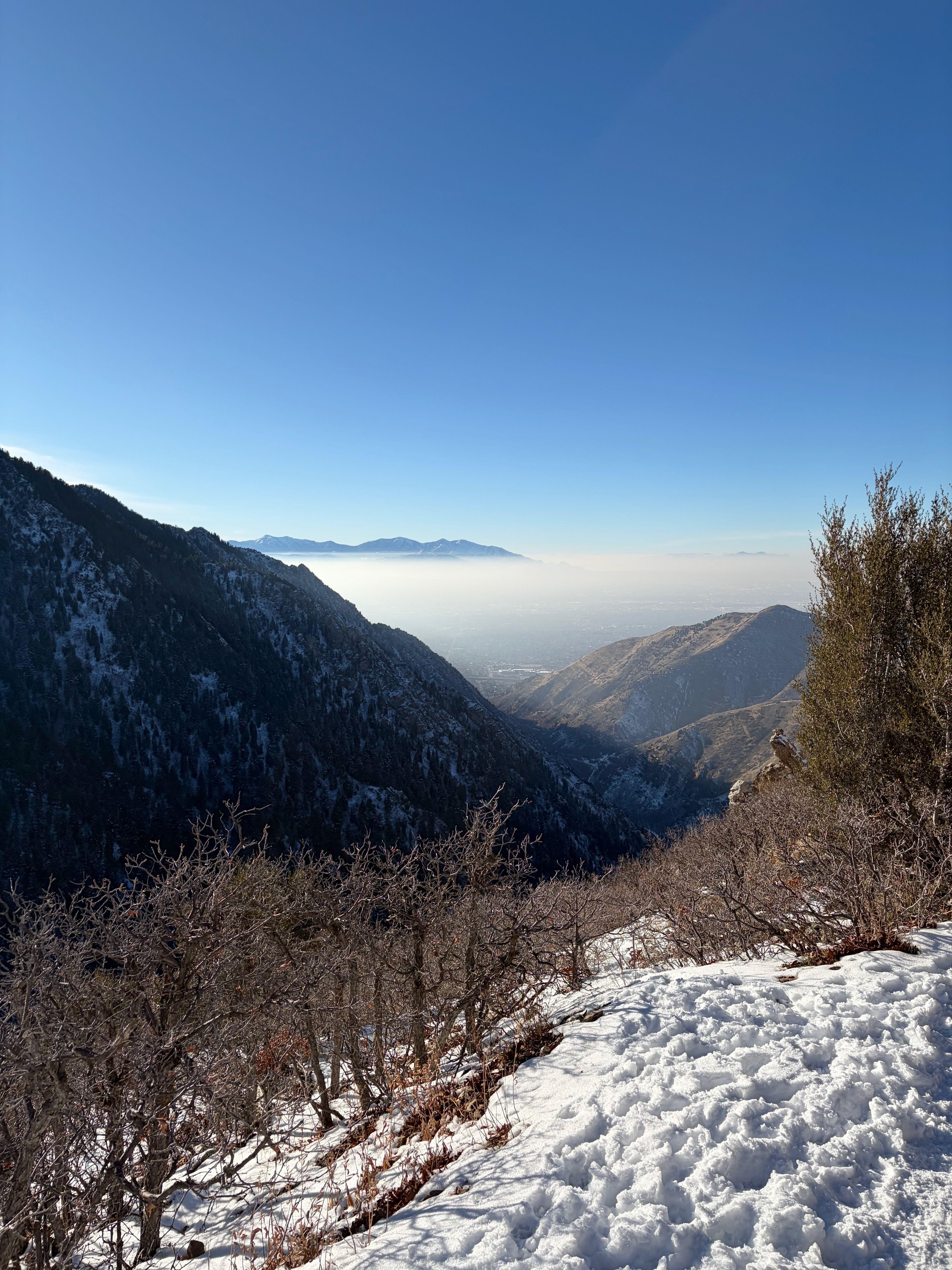 Haze hangs between the walls of a mountain canyon.