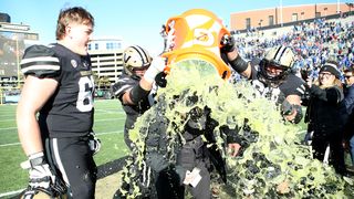 Vanderbilt players shower coach Clark Lea with gatorade to celebrate the team's victory over Florida.