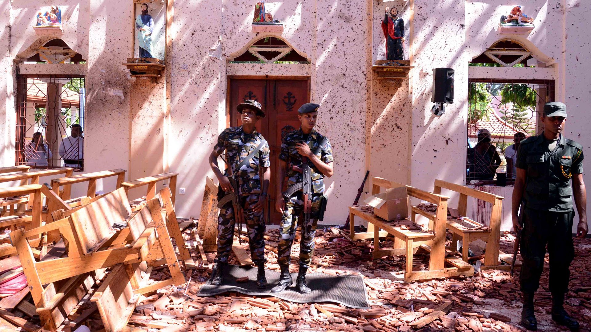  Sri Lankan soldiers look on inside the St Sebastian's Church at Katuwapitiya in Negombo on Sunday.